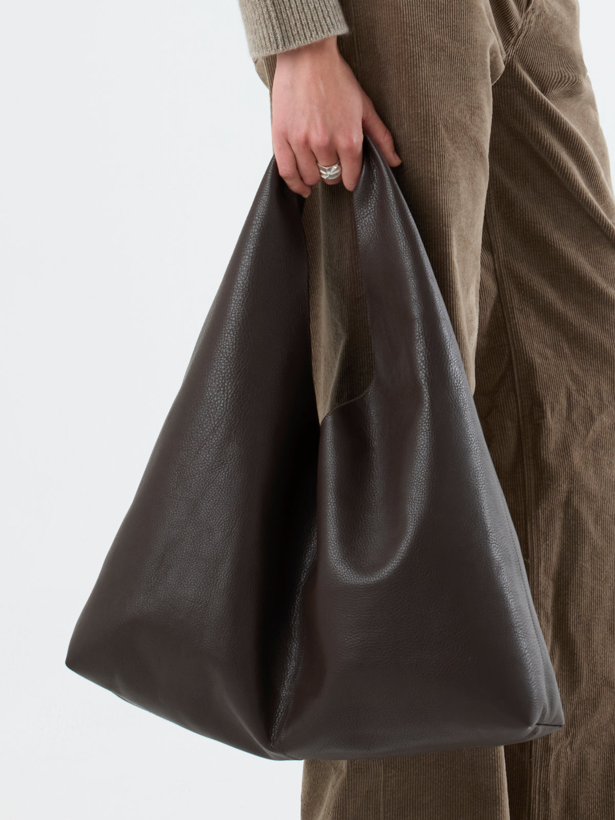 woman wearing Clara Large Leather Shoulder Bag in chocolate brown by gushlow & Cole 