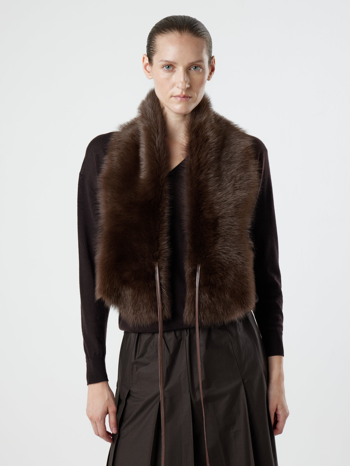 woman wearing Brown Shearling Shawl Scarf with nappa leather ties by gushlow & cole on white background