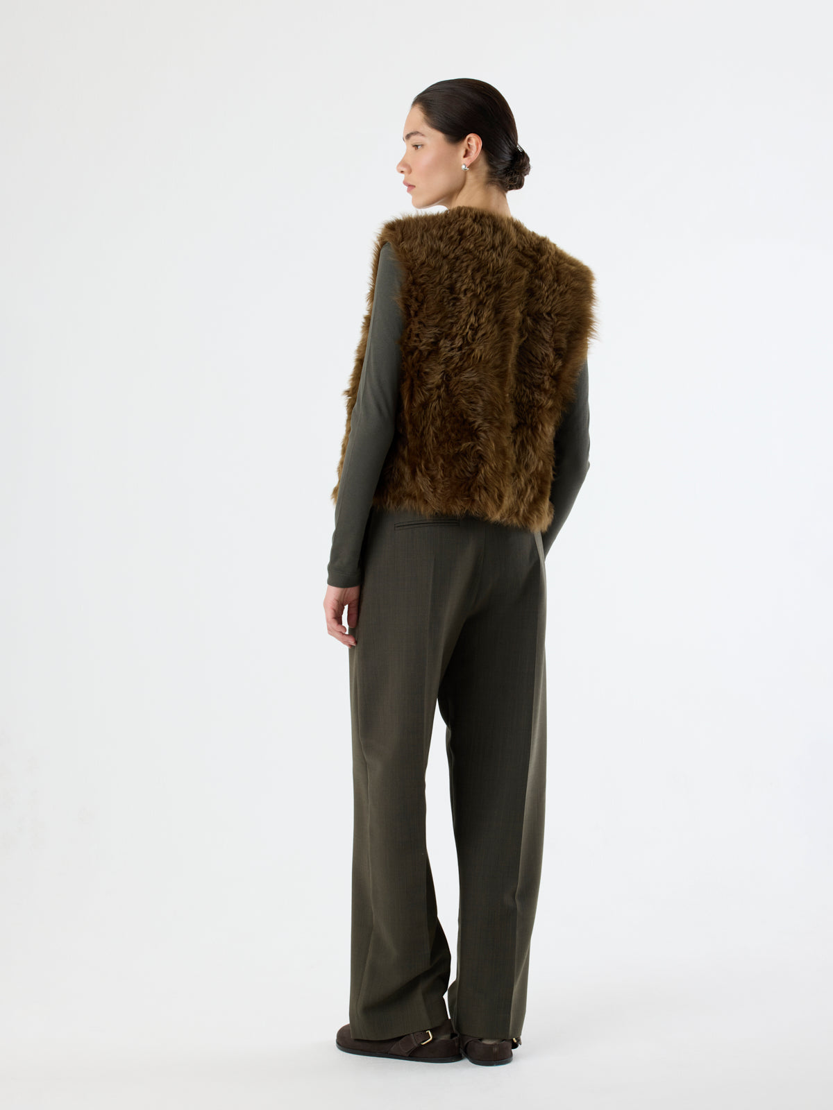 back of woman wearing slip-on chestnut brown Two Button Shearling Vest by gushlow & cole
