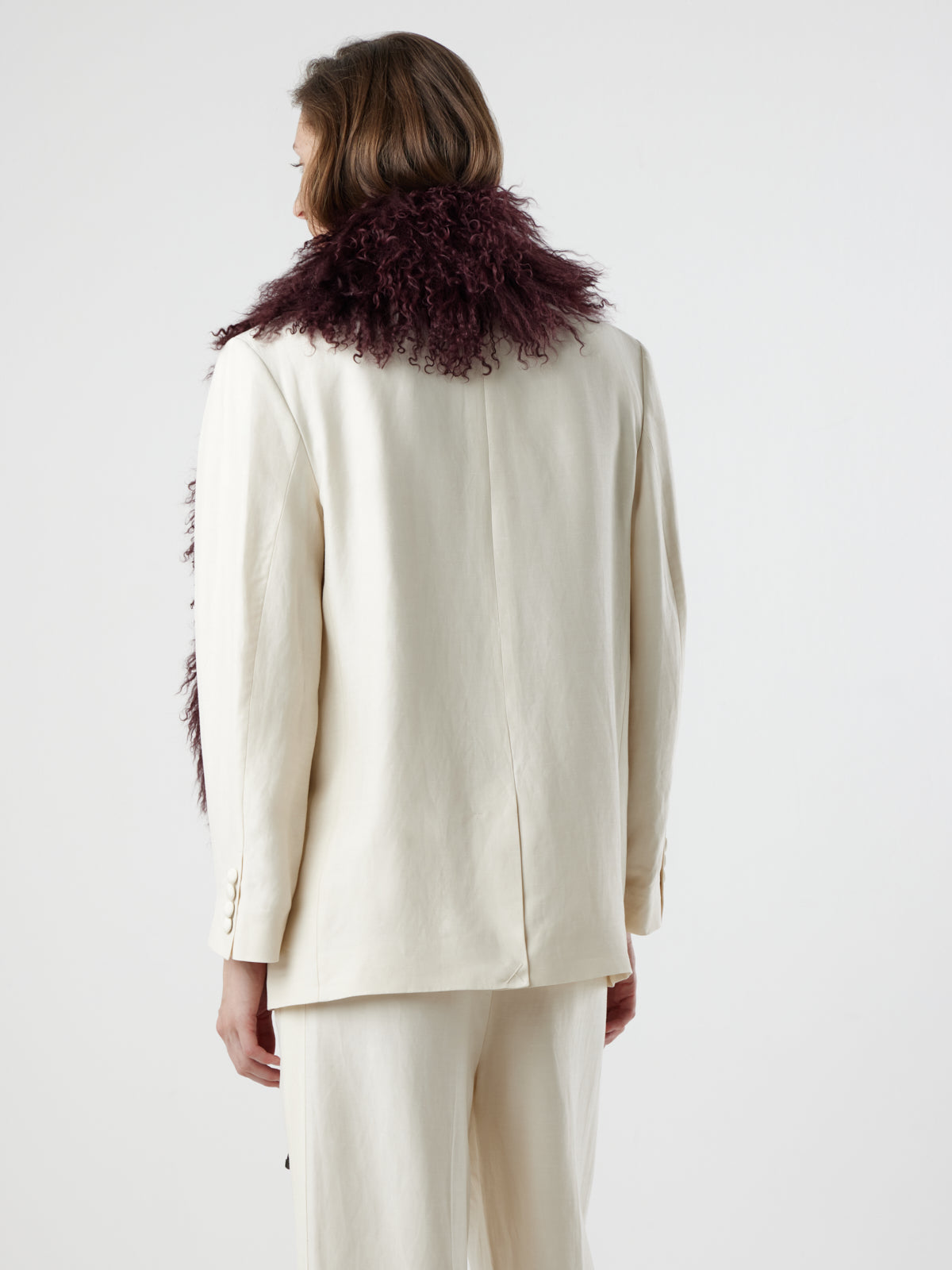 back view of woman wearing Burgundy Mongolian Shearling Shawl Scarf by gushlow & cole on white background