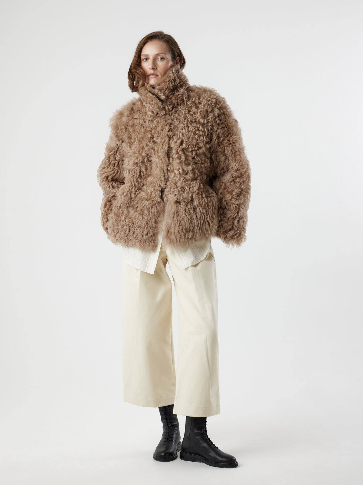 woman wearing Camel Relaxed Fit Curly Shearling Jacket by gushlow & cole / curly sheepskin Jacket