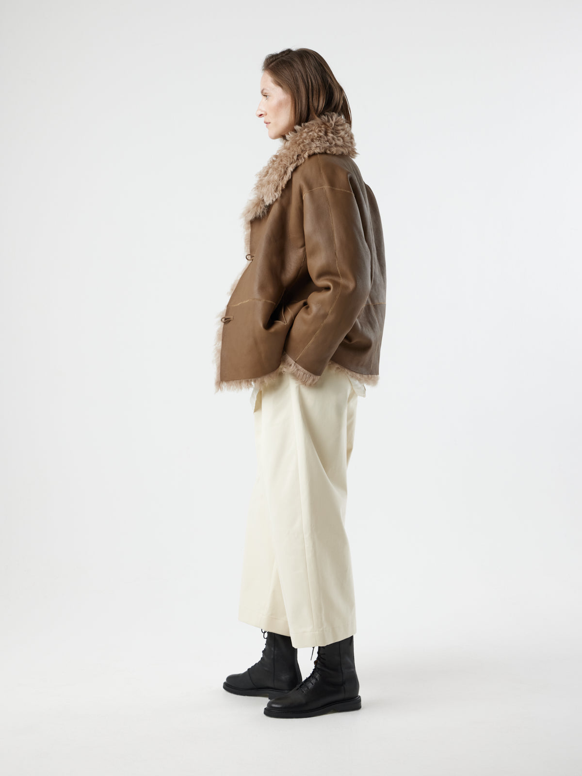 woman wearing reversed Camel Relaxed Fit Curly Shearling Jacket by gushlow & cole / curly sheepskin Jacket