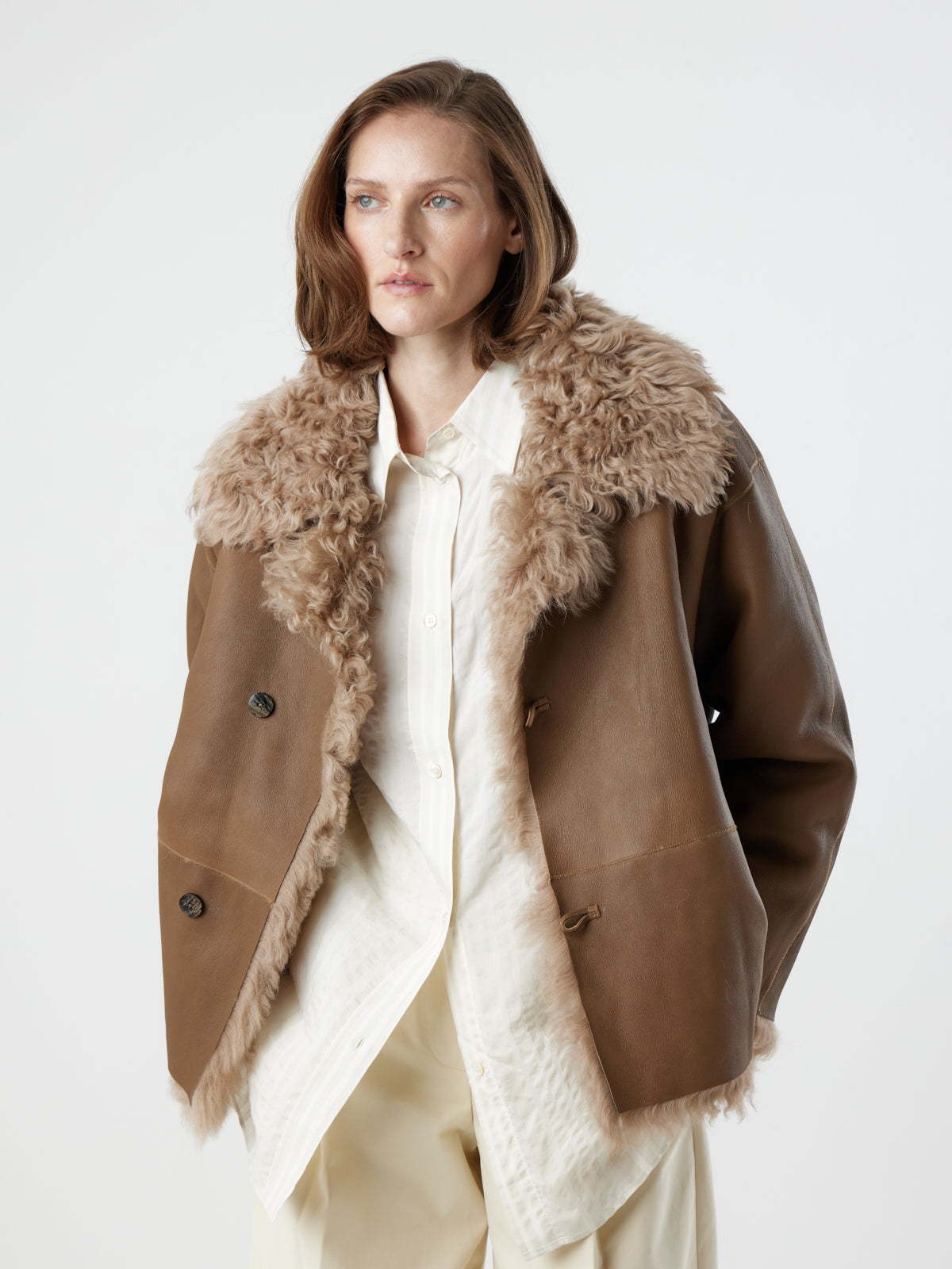 woman wearing reversed Camel Relaxed Fit Curly Shearling Jacket by gushlow & cole / curly sheepskin Jacket
