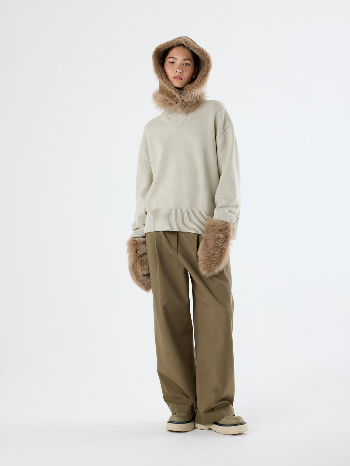 woman wearing Camel Touchscreen Shearling Mittens and camel shearling hood by Gushlow & Cole on white background