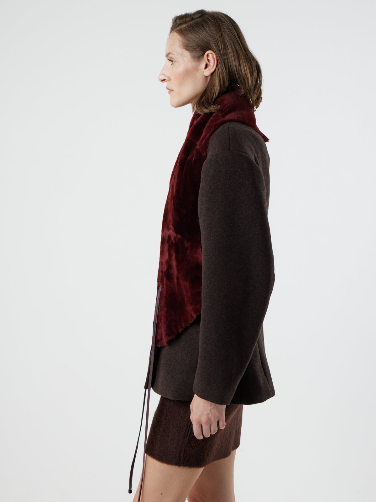 woman wearing cherry red shearling shawl scarf by gushlow & cole