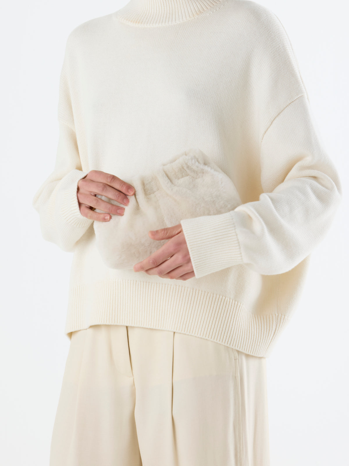 close up of women holding Cream Mini Soft Shearling Clutch Bag by Gushlow & Cole