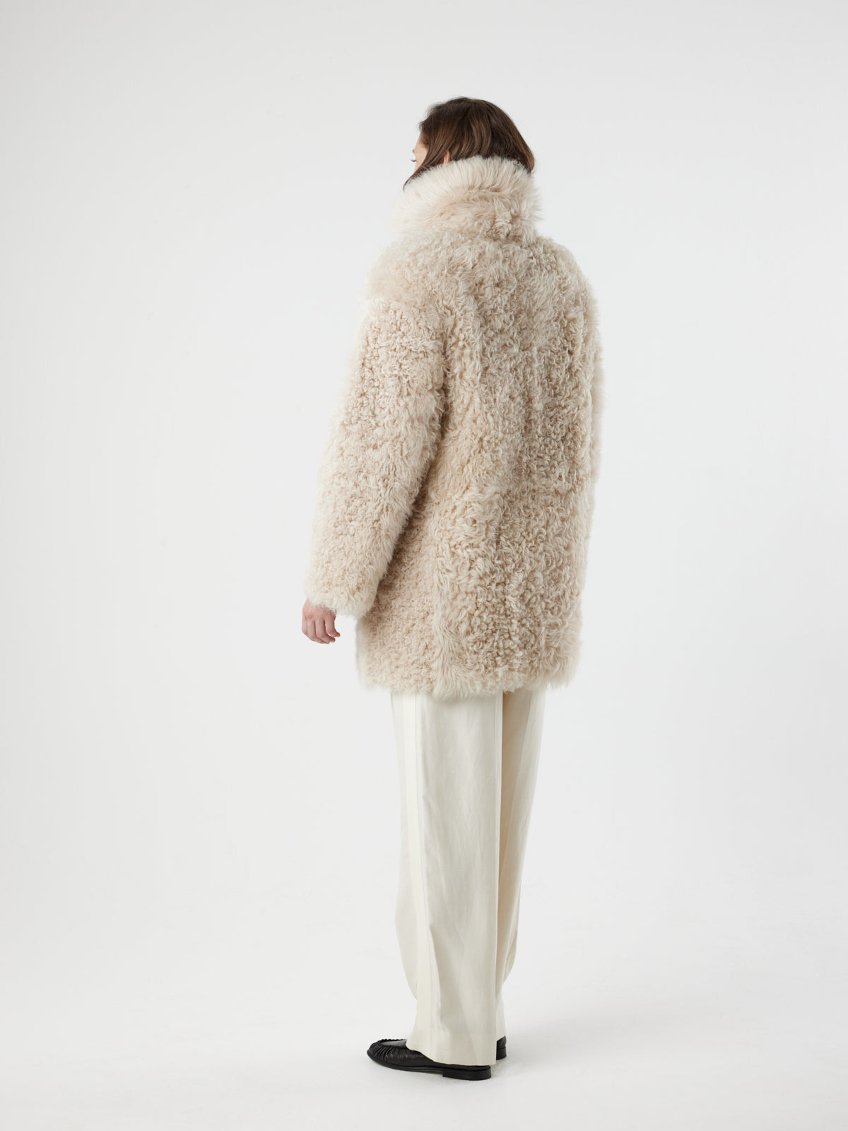 back view of woman on white background wearing Cream Relaxed Fit Curly Shearling Coat by gushlow & cole