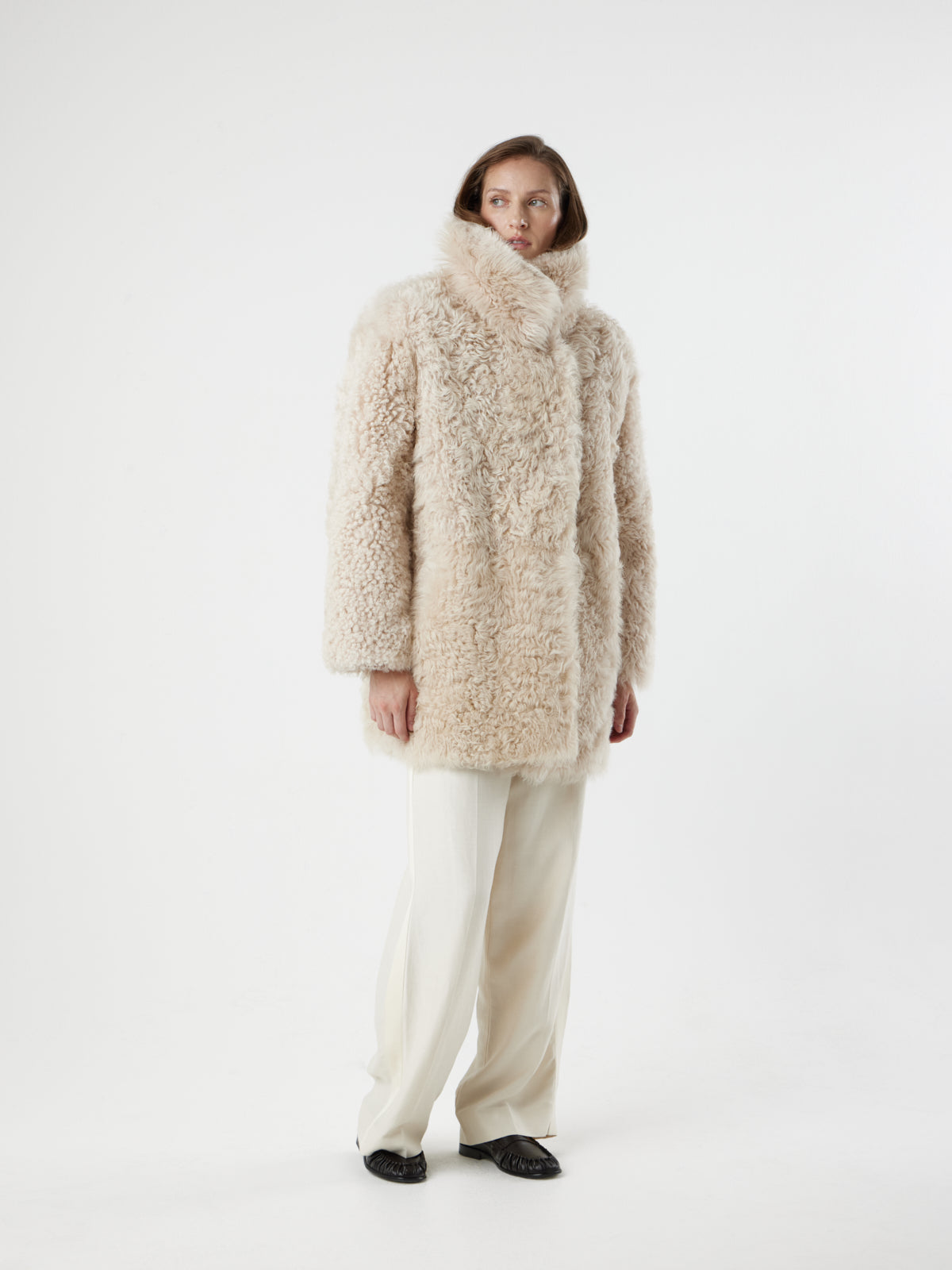 women on white background wearing Cream Relaxed Fit Curly Shearling Coat by gushlow & cole 