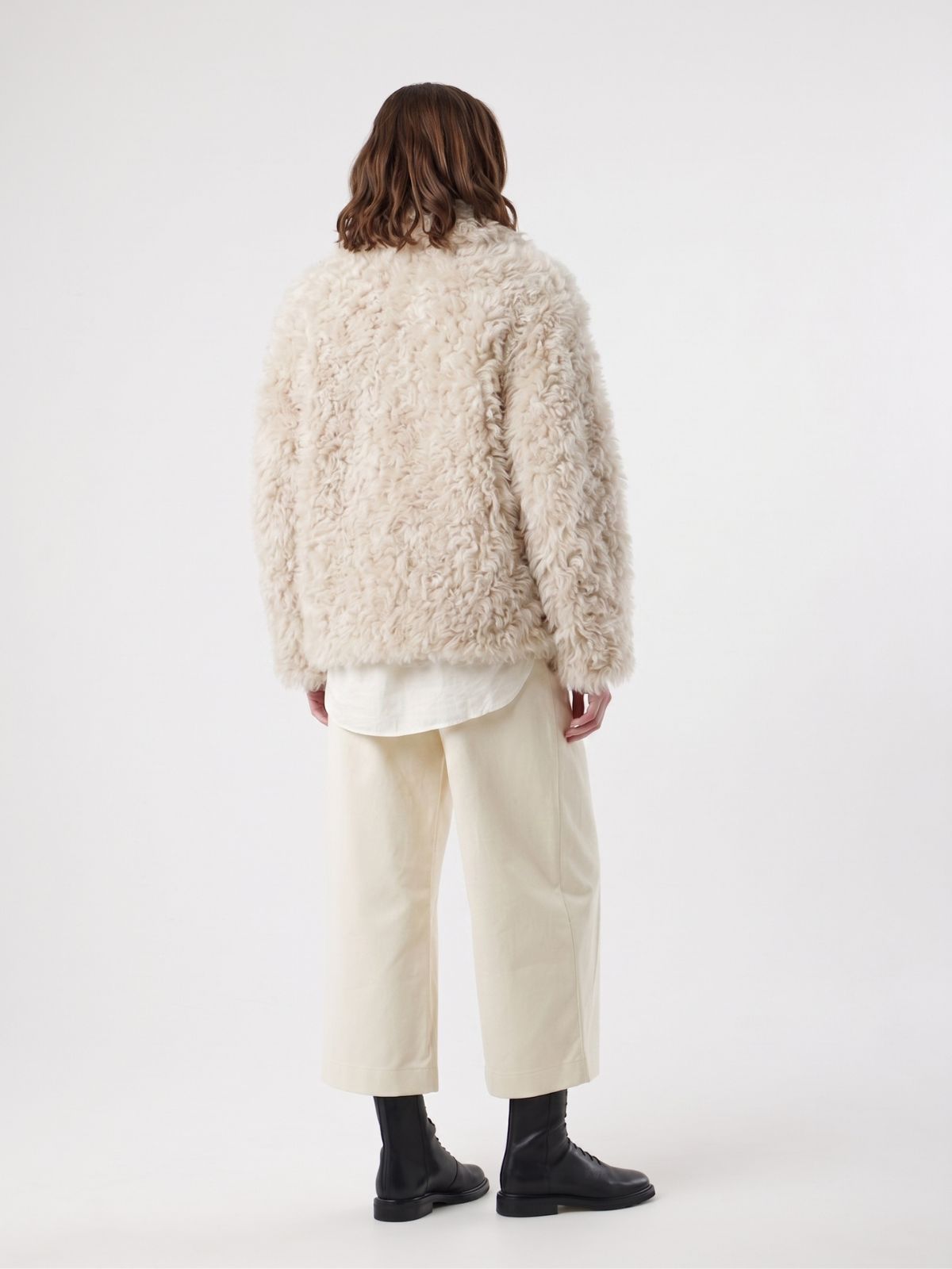 back view of woman wearing Cream Relaxed Fit Curly Shearling Jacket by gushlow & cole / curly sheepskin Jacket