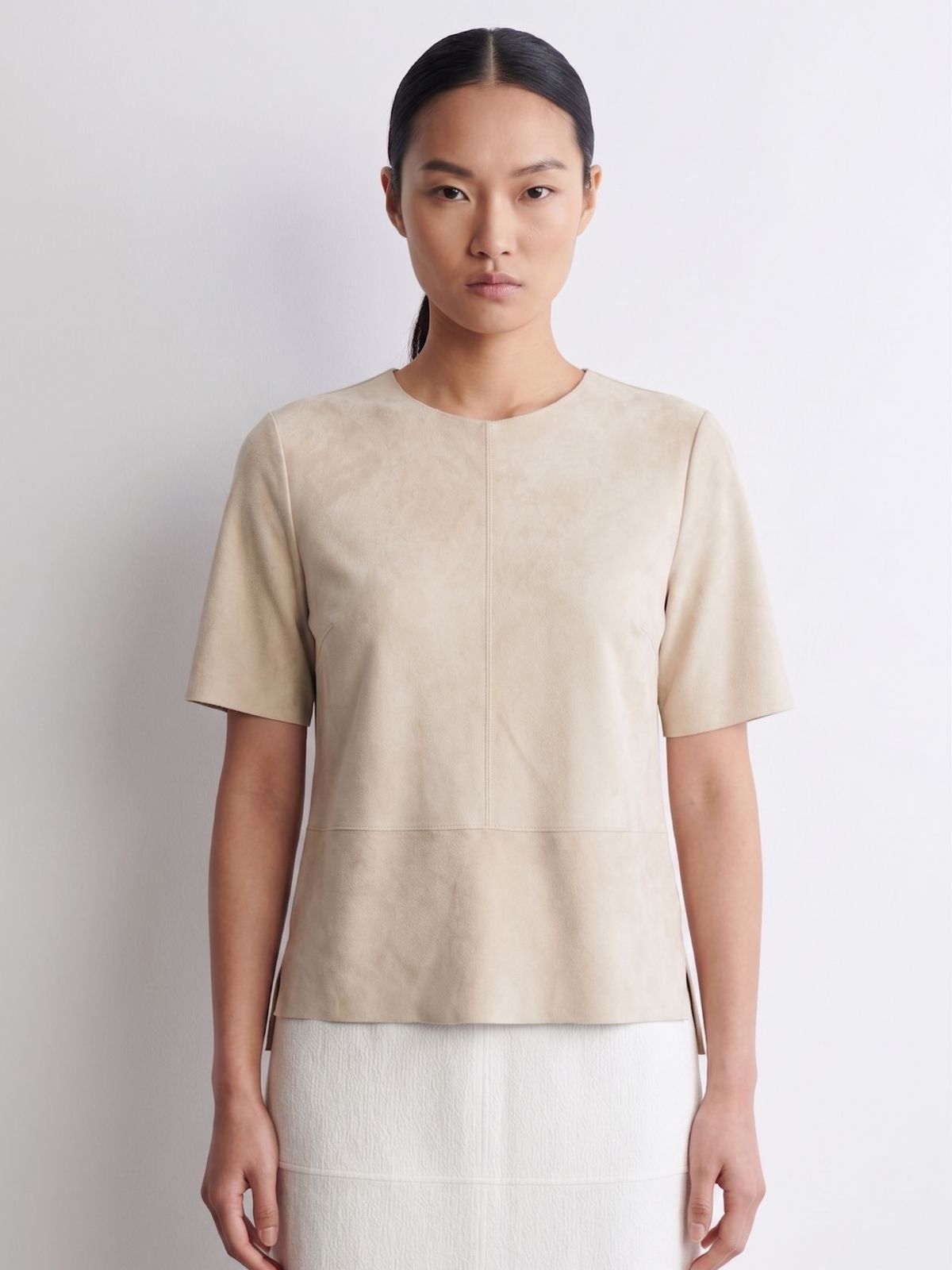 woman wearing cream suede t shirt top and cream skirt on white background by gushlow & cole