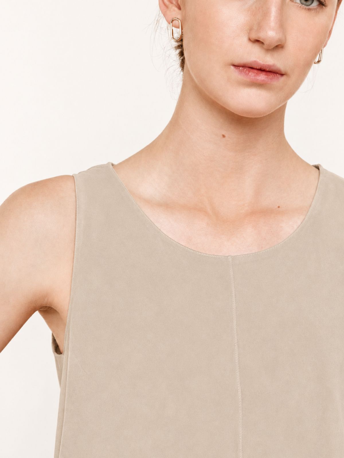 crop in of woman wearing cream suede vest top on white background by gushlow & cole