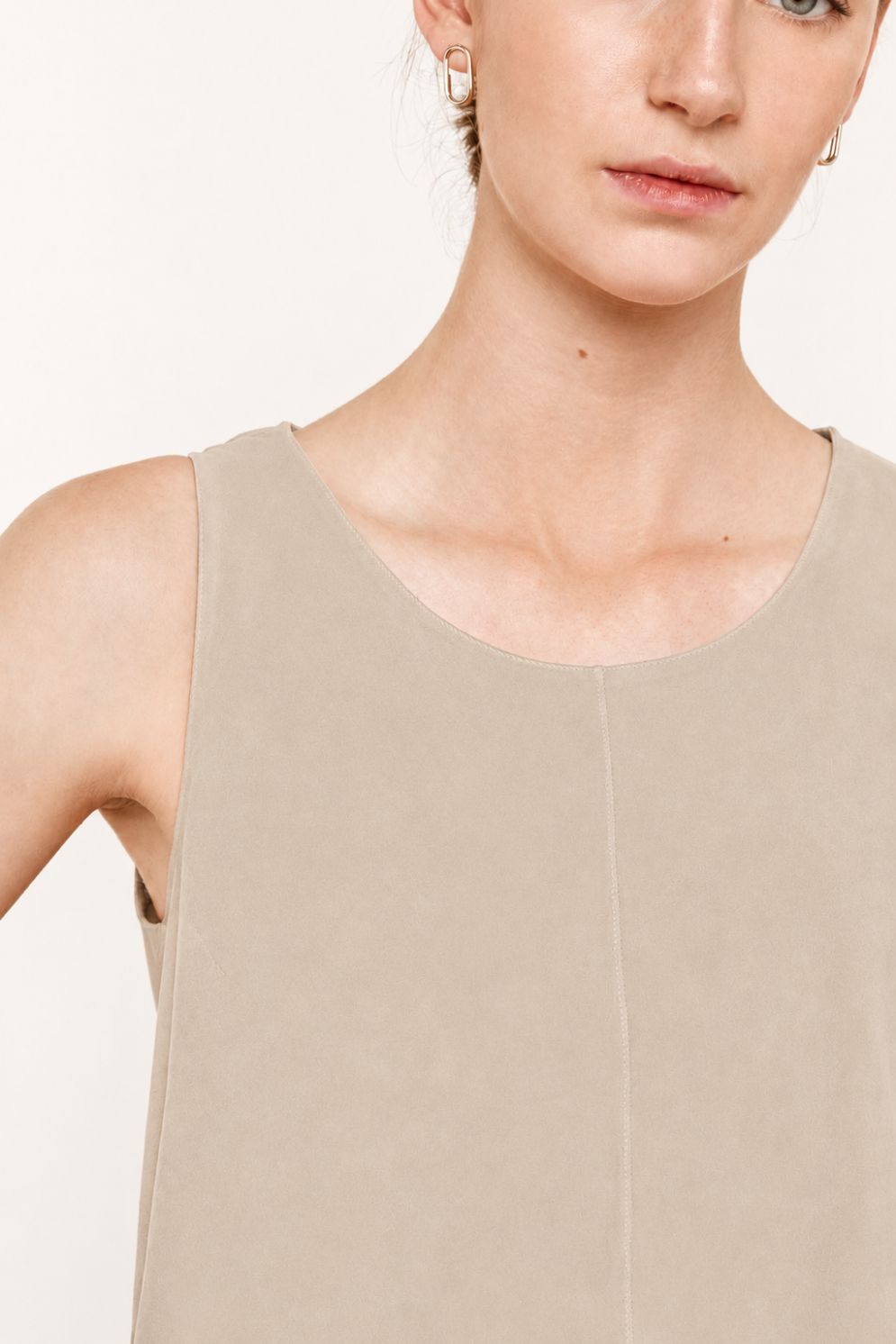crop in of woman wearing cream suede vest top on white background by gushlow & cole