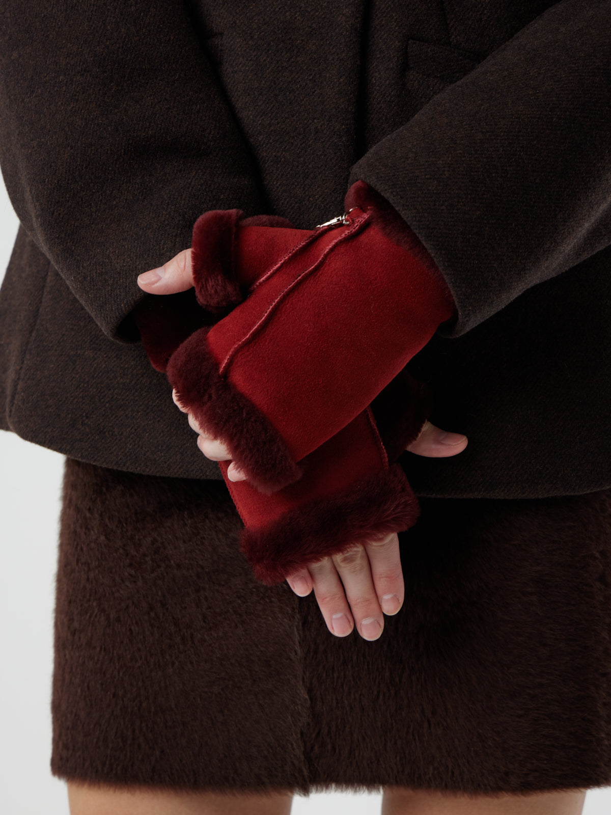 woman wearing pair of Fingerless Red Shearling Mittens by Gushlow & Cole