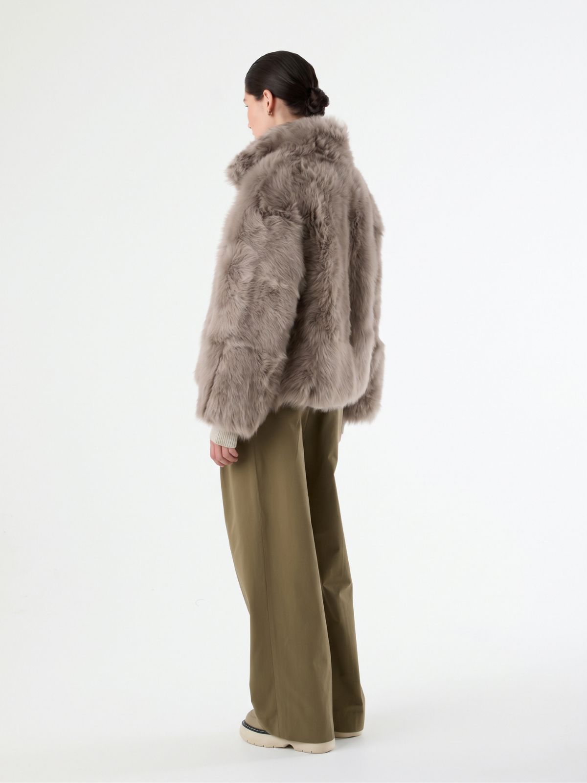 back view of woman wearing Funnel Collar taupe Shearling jacket by gushlow & cole
