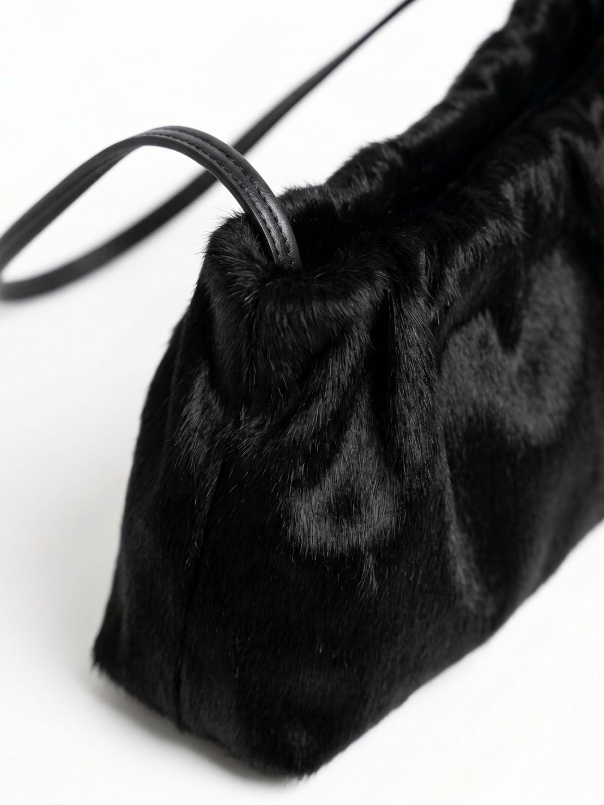 detail shot of ghia small black shoulder bag made in calfskin on white background by gushlow & cole