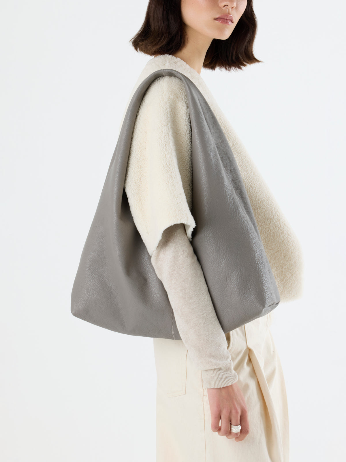 woman wearing Clara Large Leather Shoulder Bag in grey by gushlow & Cole over shoulder