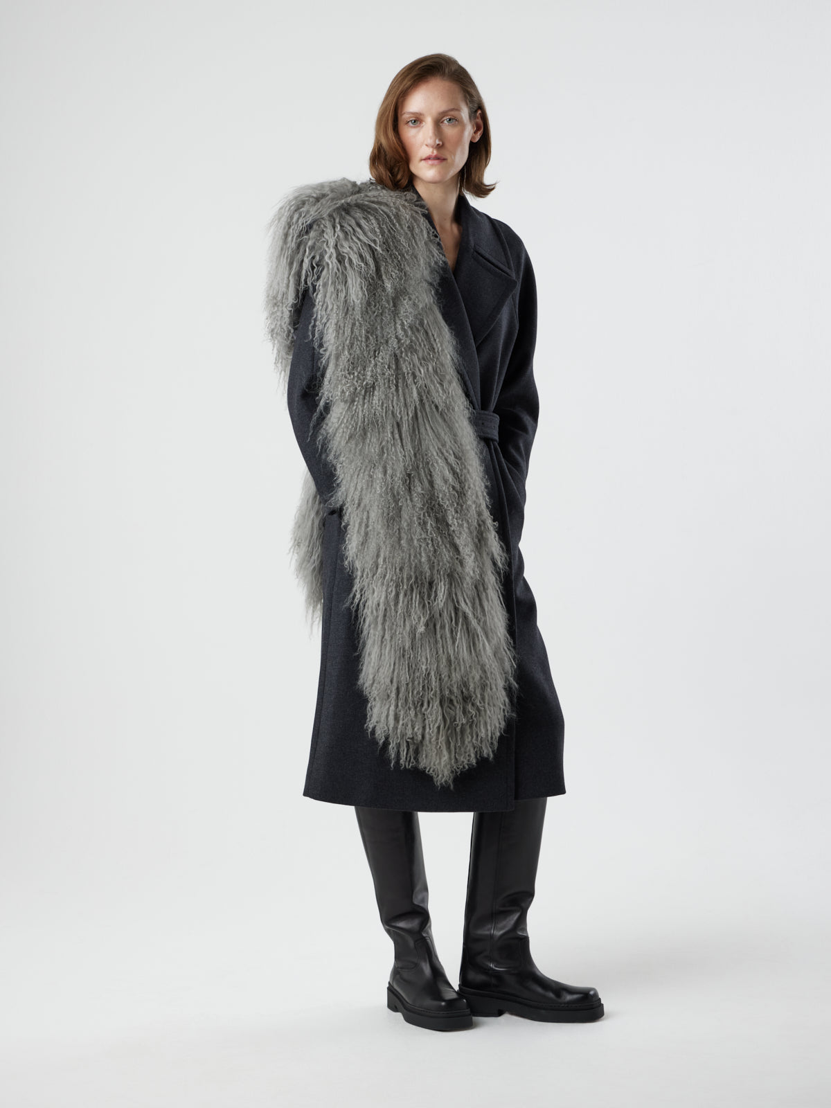 woman wearing grey mongolian pocket scarf by gushlow & cole draped over shoulder