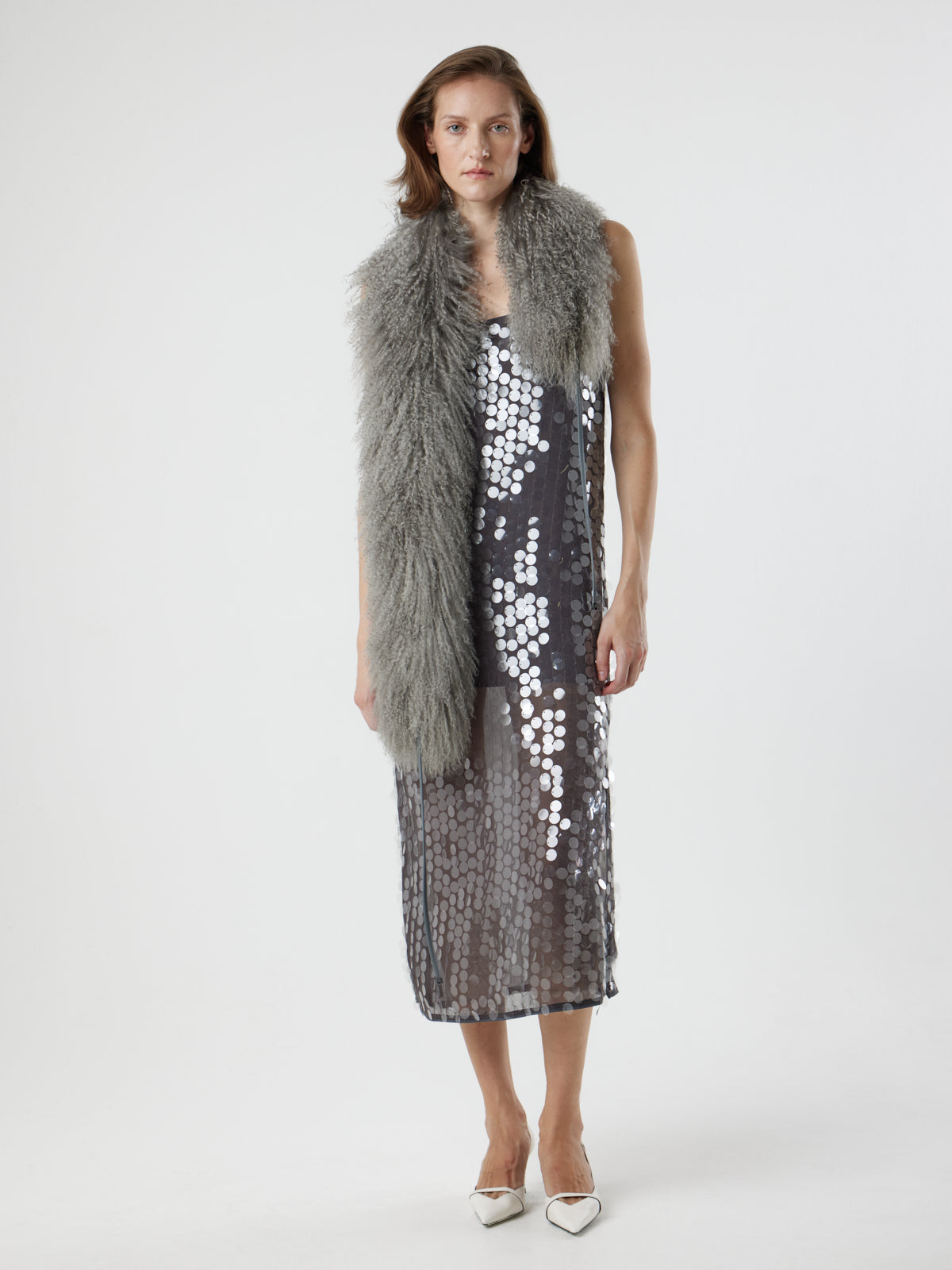 woman wearing grey Mongolian Shearling Shawl Scarf, styled over dress, by gushlow & cole on white background