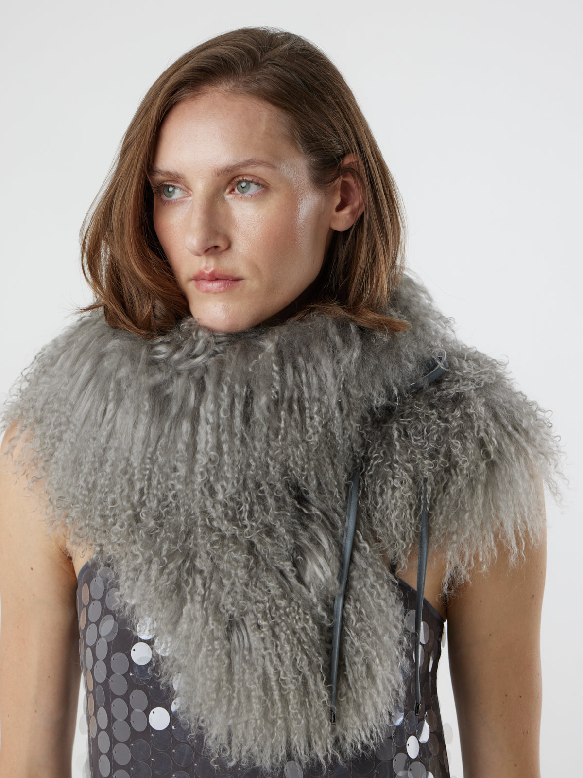 woman wearing grey Mongolian Shearling Shawl Scarf, styled as a snood, by gushlow & cole on white background