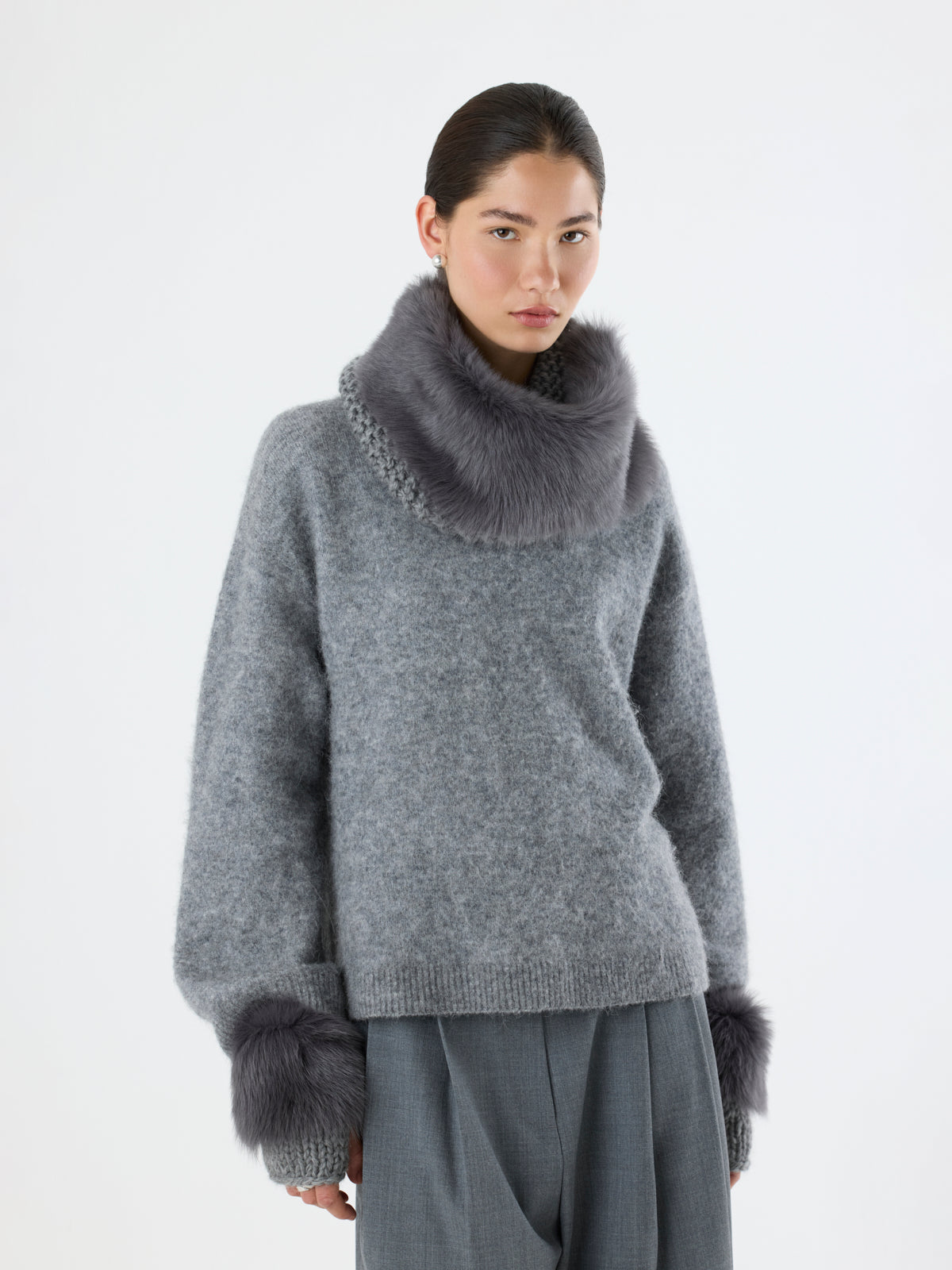 woman wearing Grey Shearling and Knit Mittens and grey shearling and knit snood by Gushlow & Cole over grey jumper