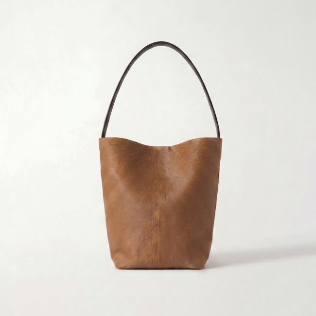 tan calfskin bucket bag by gushlow & cole on white background