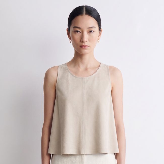 woman wearing suede vest top by gushlow & cole on white background