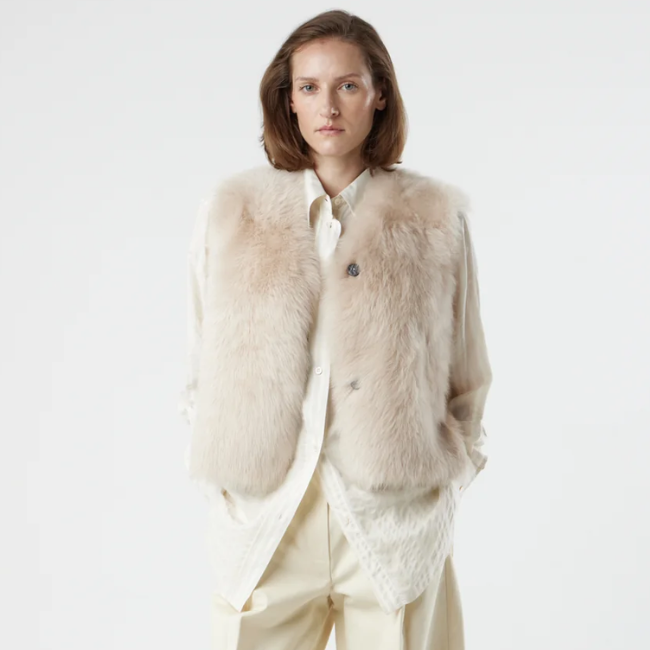 woman wearing Two Button Cream Shearling Vest by gushlow & cole on white background