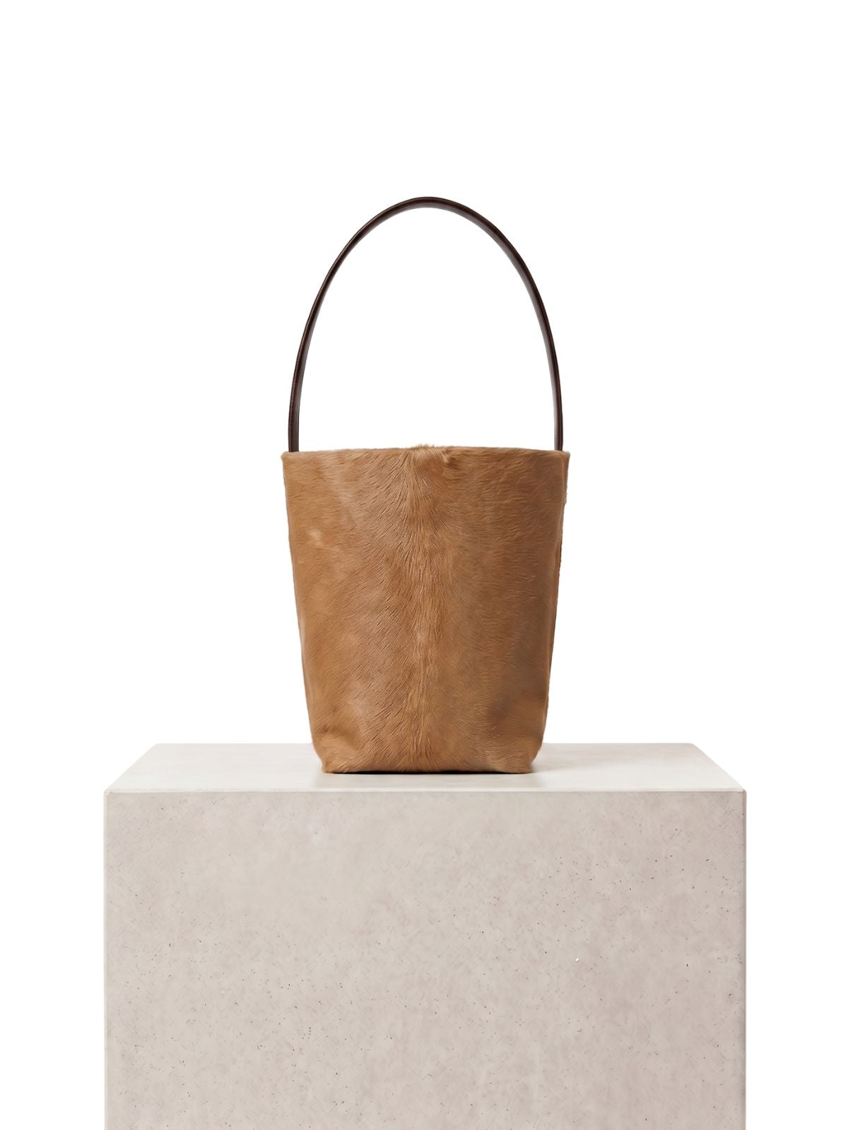 maye small camel bucket tote bag by gushlow & cole on plinth