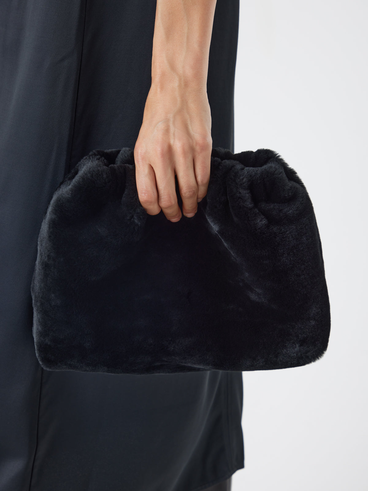 Merino Soft Black Shearling Clutch Bag | Womens | Gushlow & Cole - model crop holding bag
