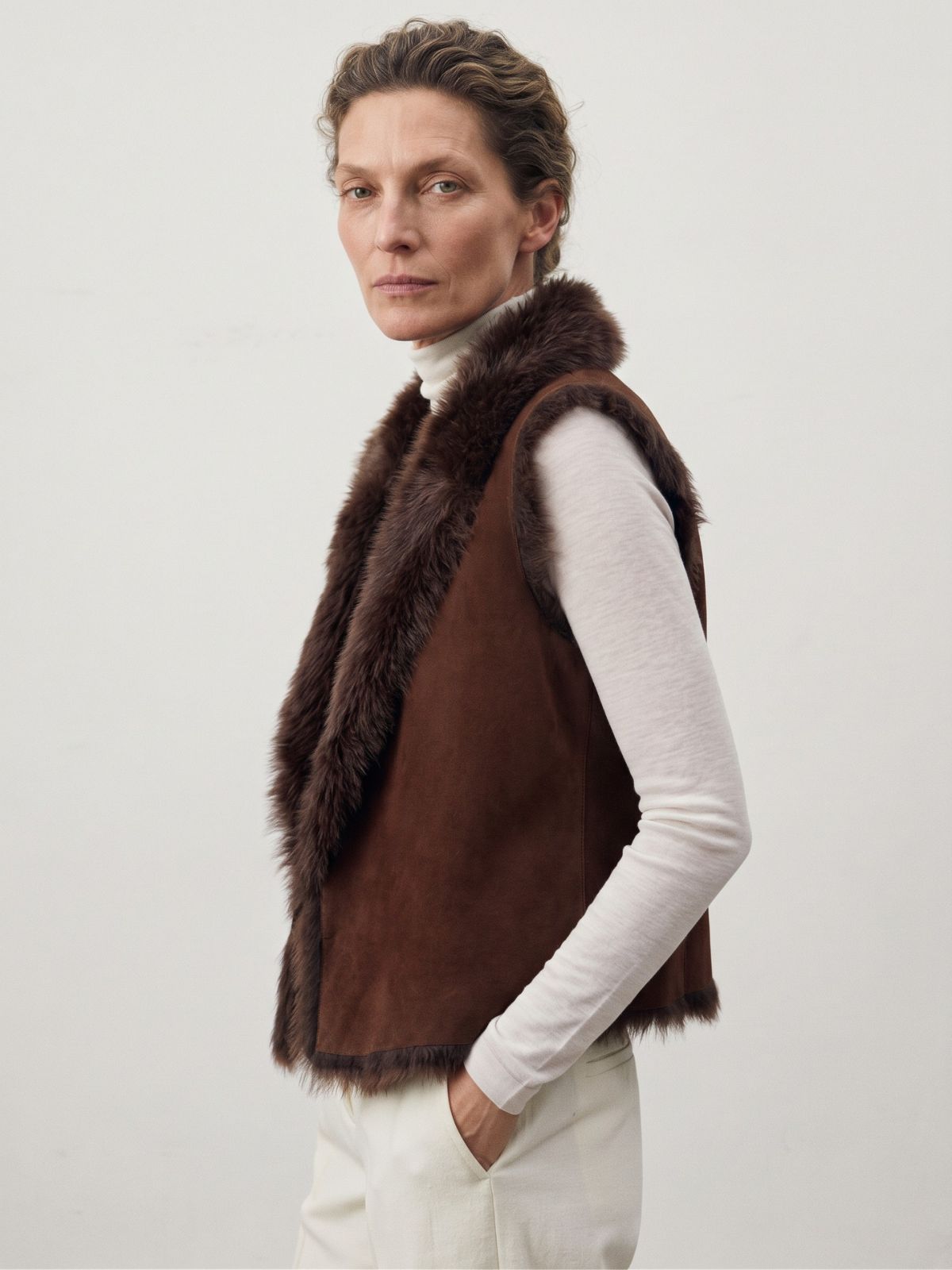 woman wearing natural edge brown shearling gilet by gushlow & cole