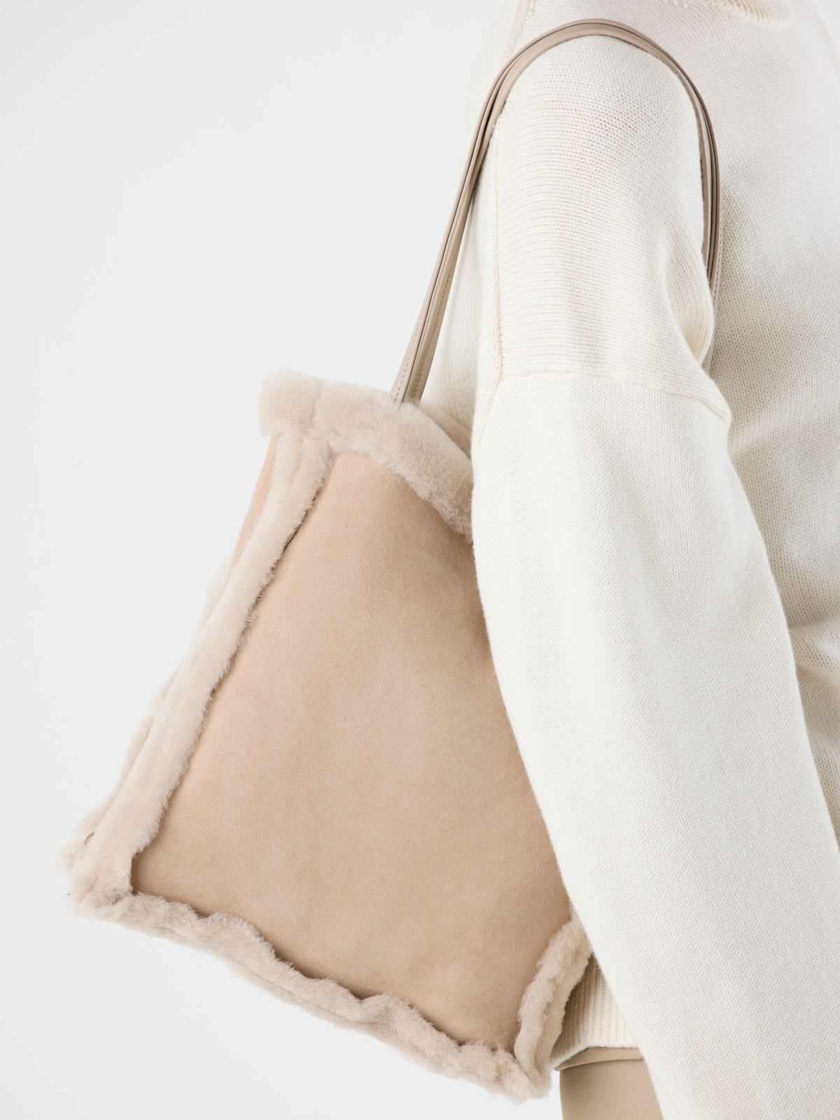 woman wearing Nell Merino Cream Shearling Tote Bag over shoulder by gushlow & cole