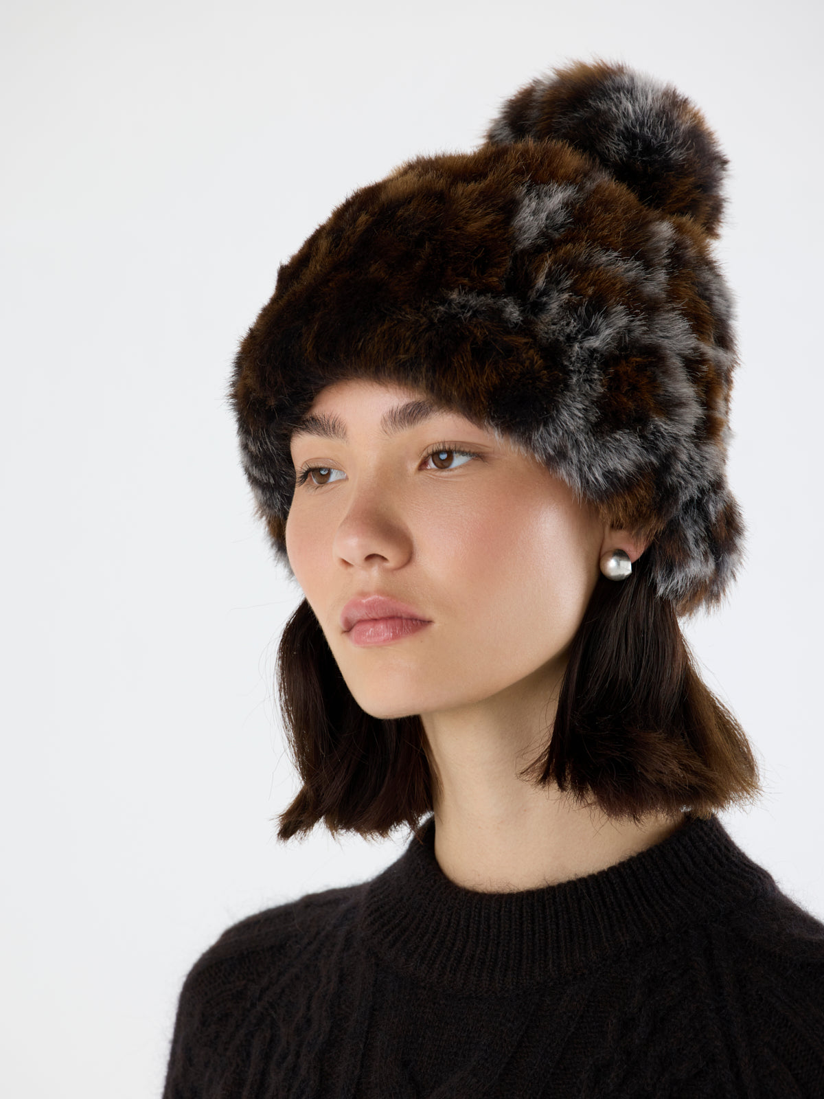 side view of woman wearing Ocelot Toscana Shearling Beanie Hat by Gushlow & Cole on white background