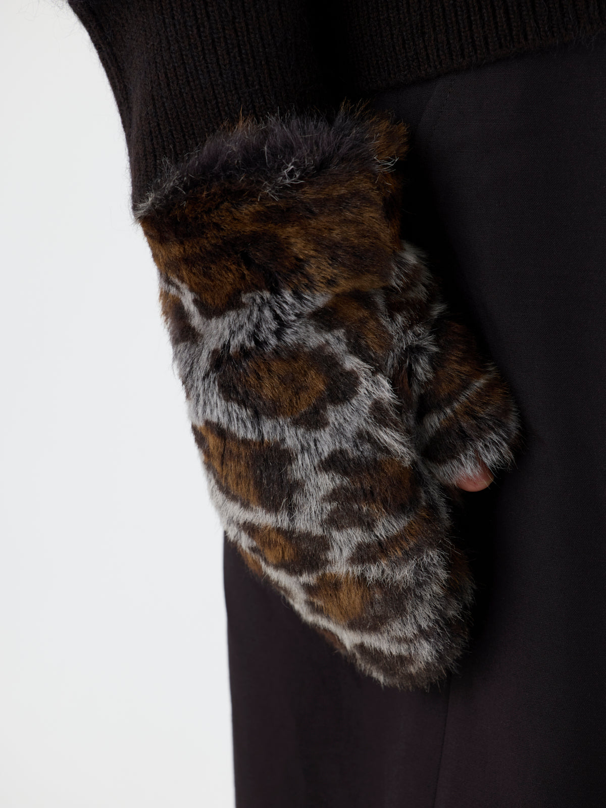 womens hand wearing womens Ocelot Touchscreen Shearling Mittens by Gushlow & Cole on white background 