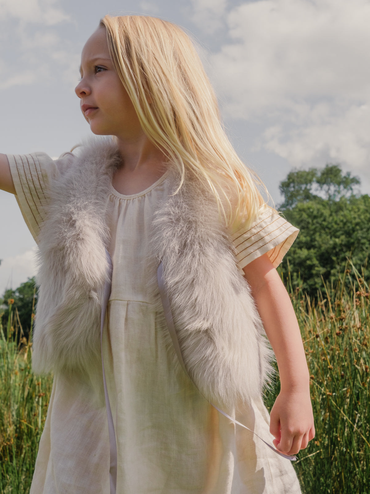 Oyster White Kids Toscana Shearling Gilet | Kids | Gushlow & Cole-on model outside