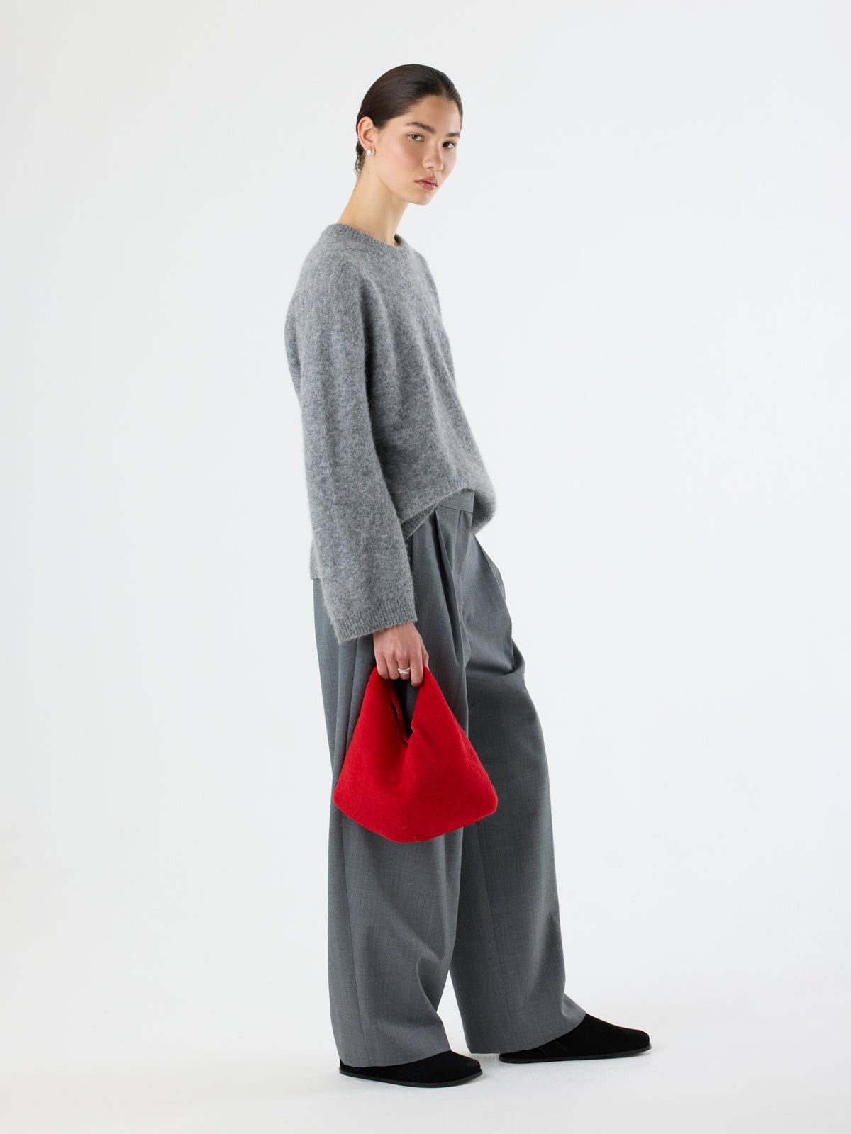 woman holding Red Clara Small Shearling Shoulder Bag by Gushlow & Cole with grey outfit