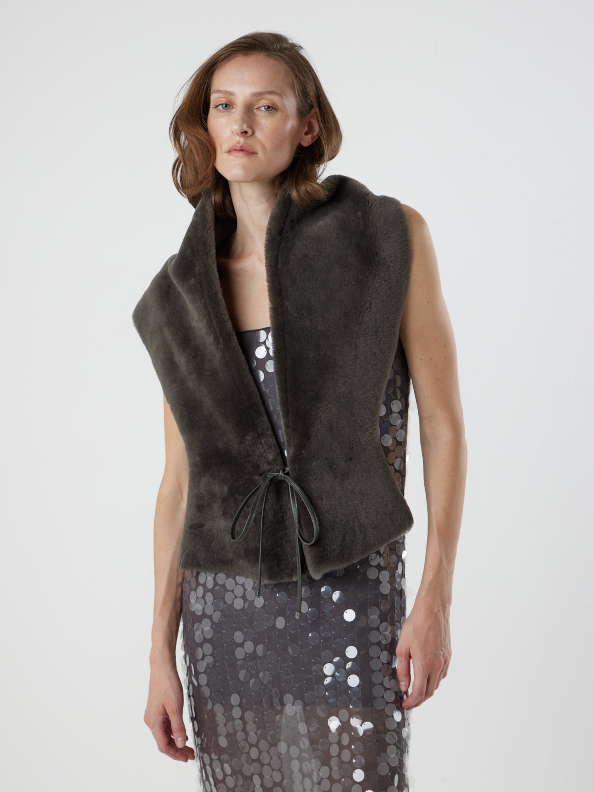 woman wearing storm brown shearling shawl scarf by gushlow & cole tied at front