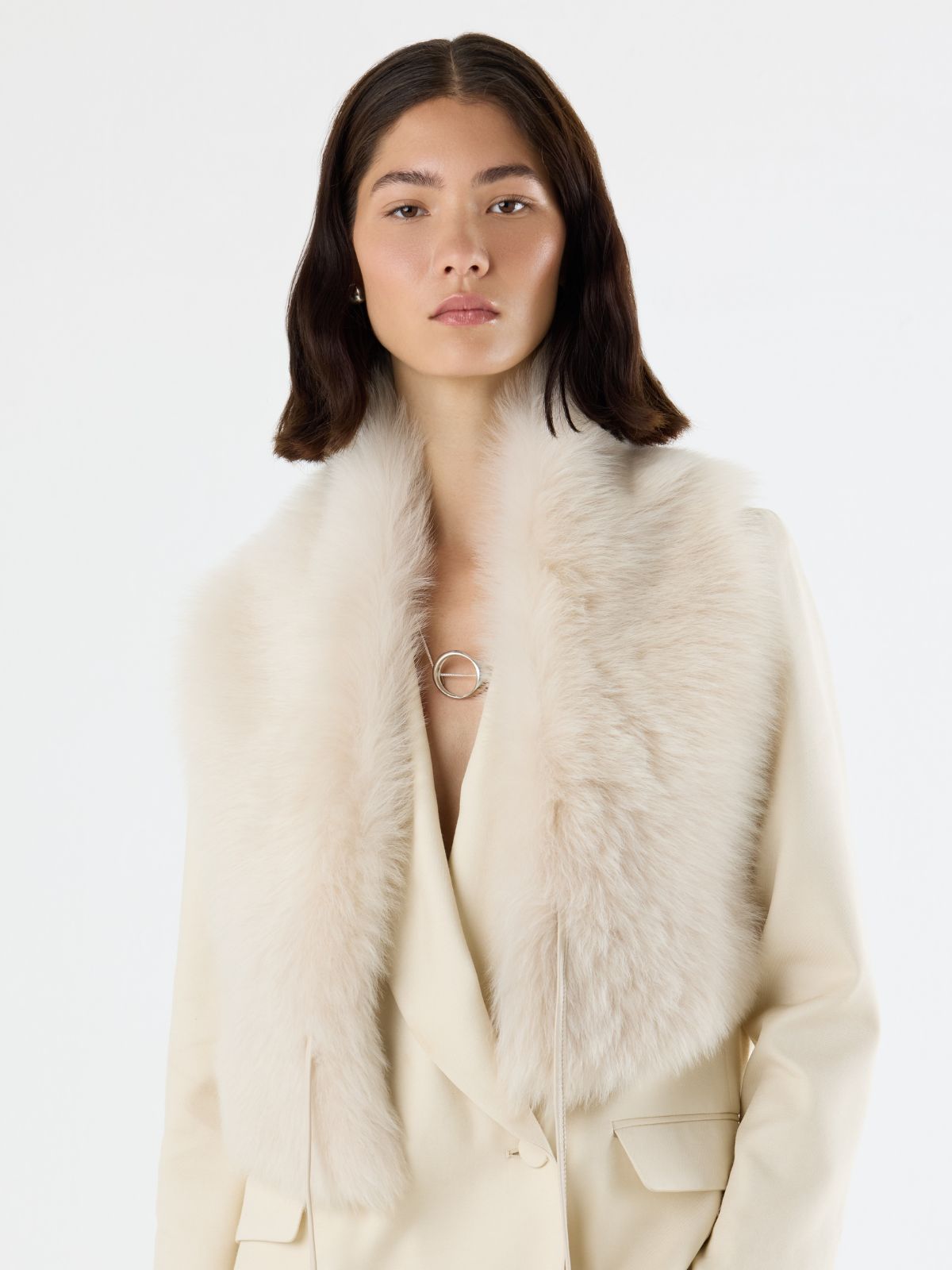 woman wearing sterling silver orbit necklace by studio agaea wearing cream shearling shawl scarf by gushlow & cole