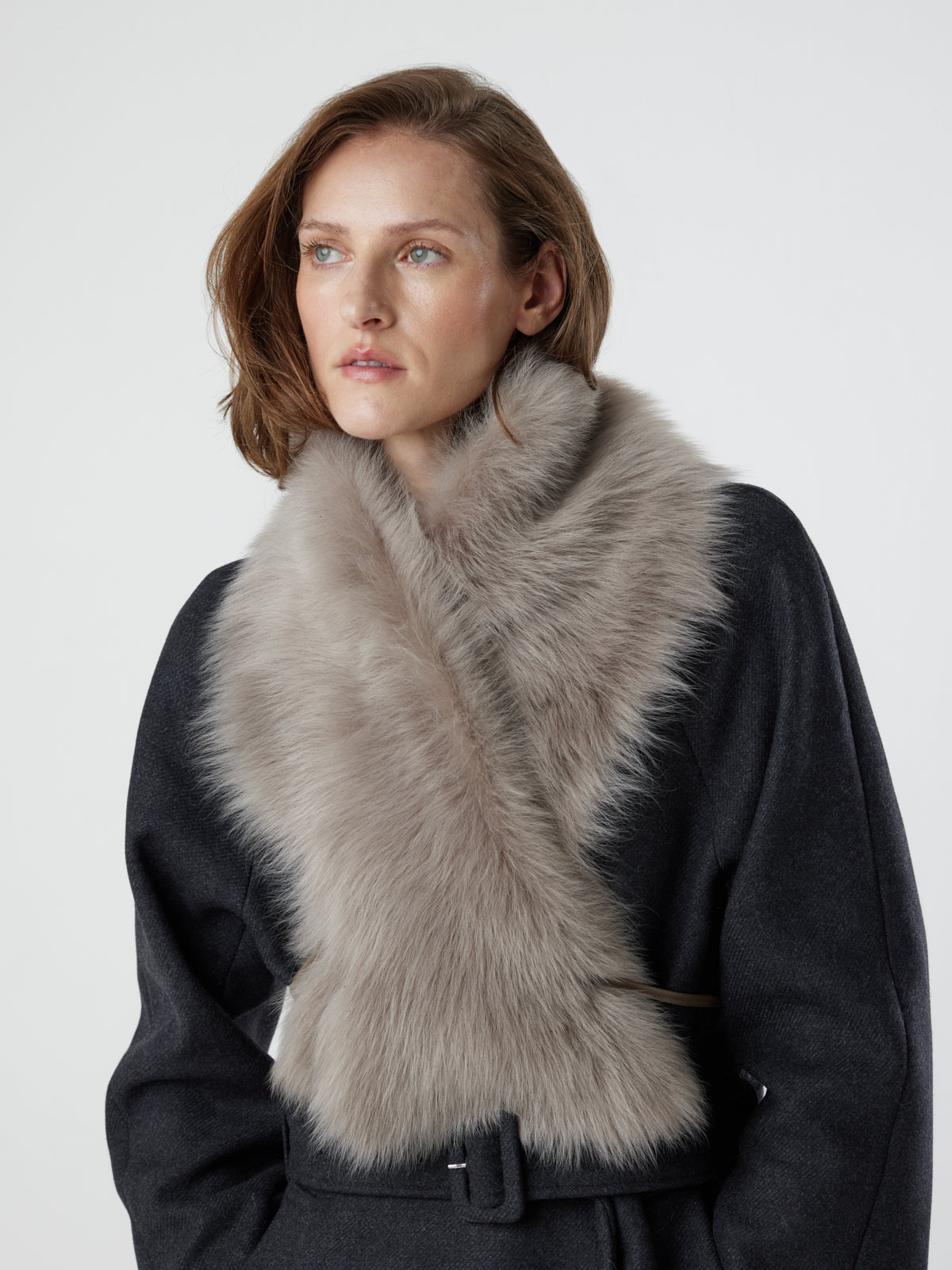 woman wearing taupe Shearling Shawl Scarf with nappa leather ties, styled crossed over, by gushlow & cole on white background