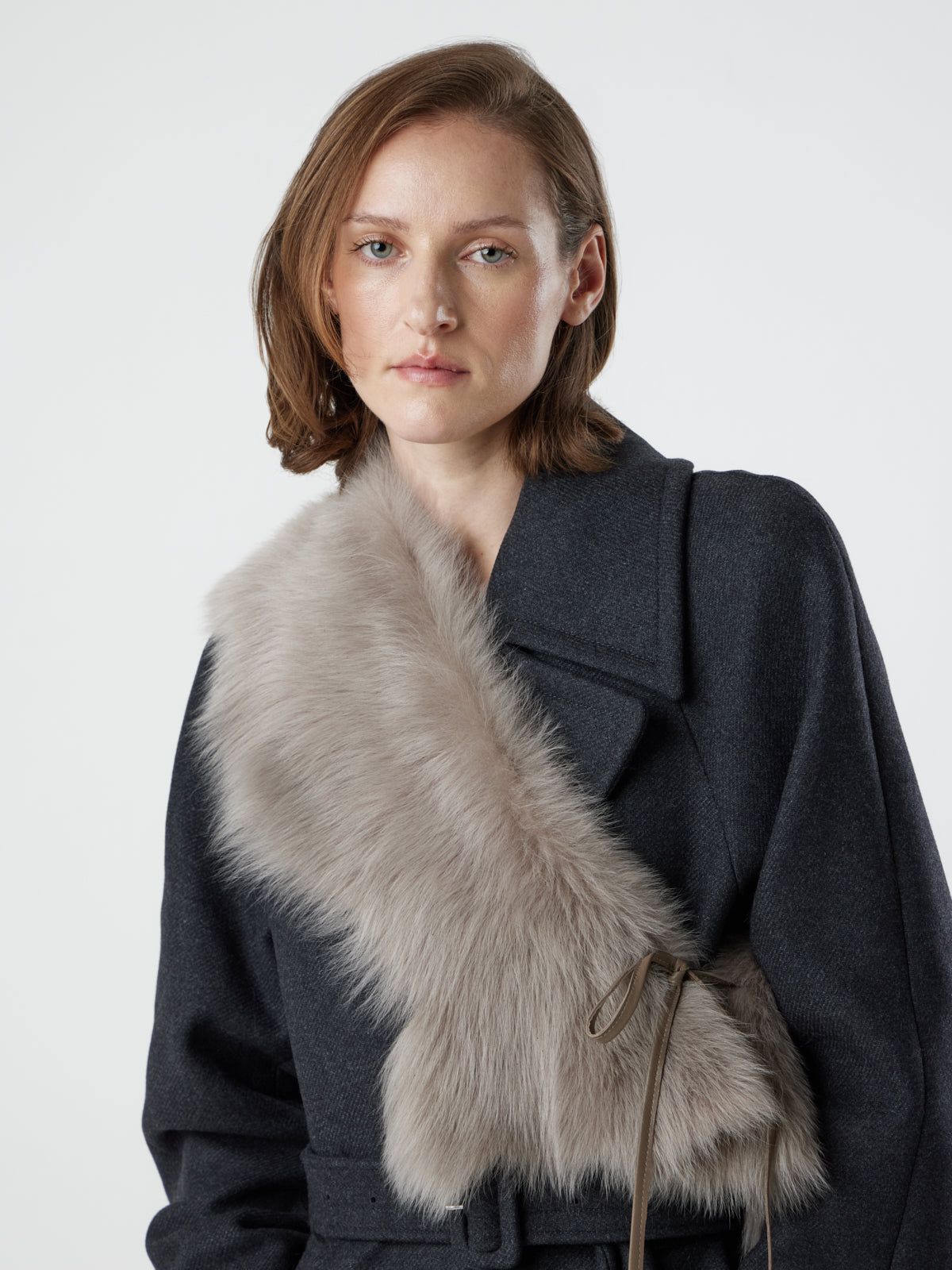woman wearing taupe Shearling Shawl Scarf with nappa leather ties, styled as a sash, by gushlow & cole on white background