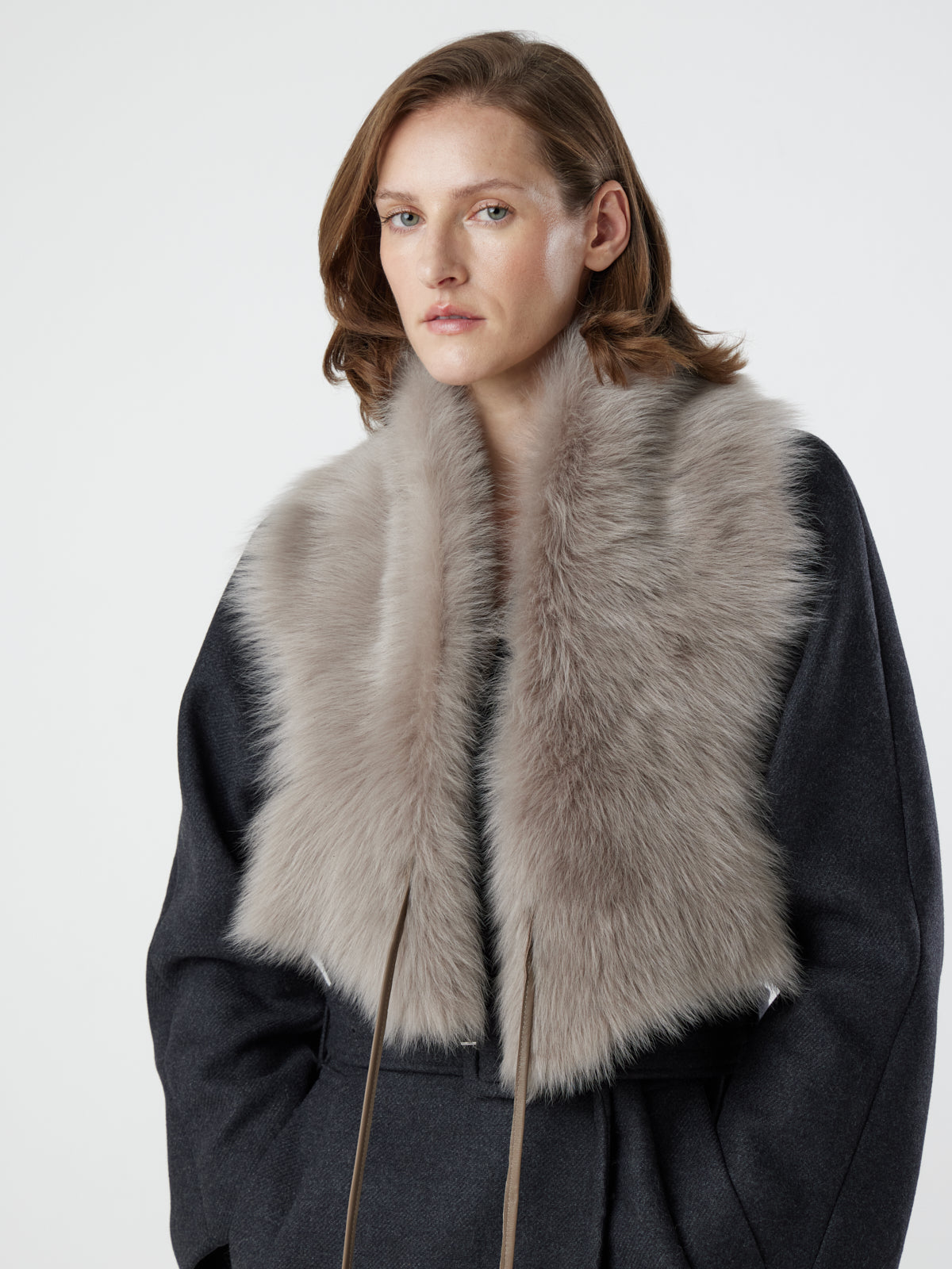woman wearing taupe Shearling Shawl Scarf with nappa leather ties by gushlow & cole on white background