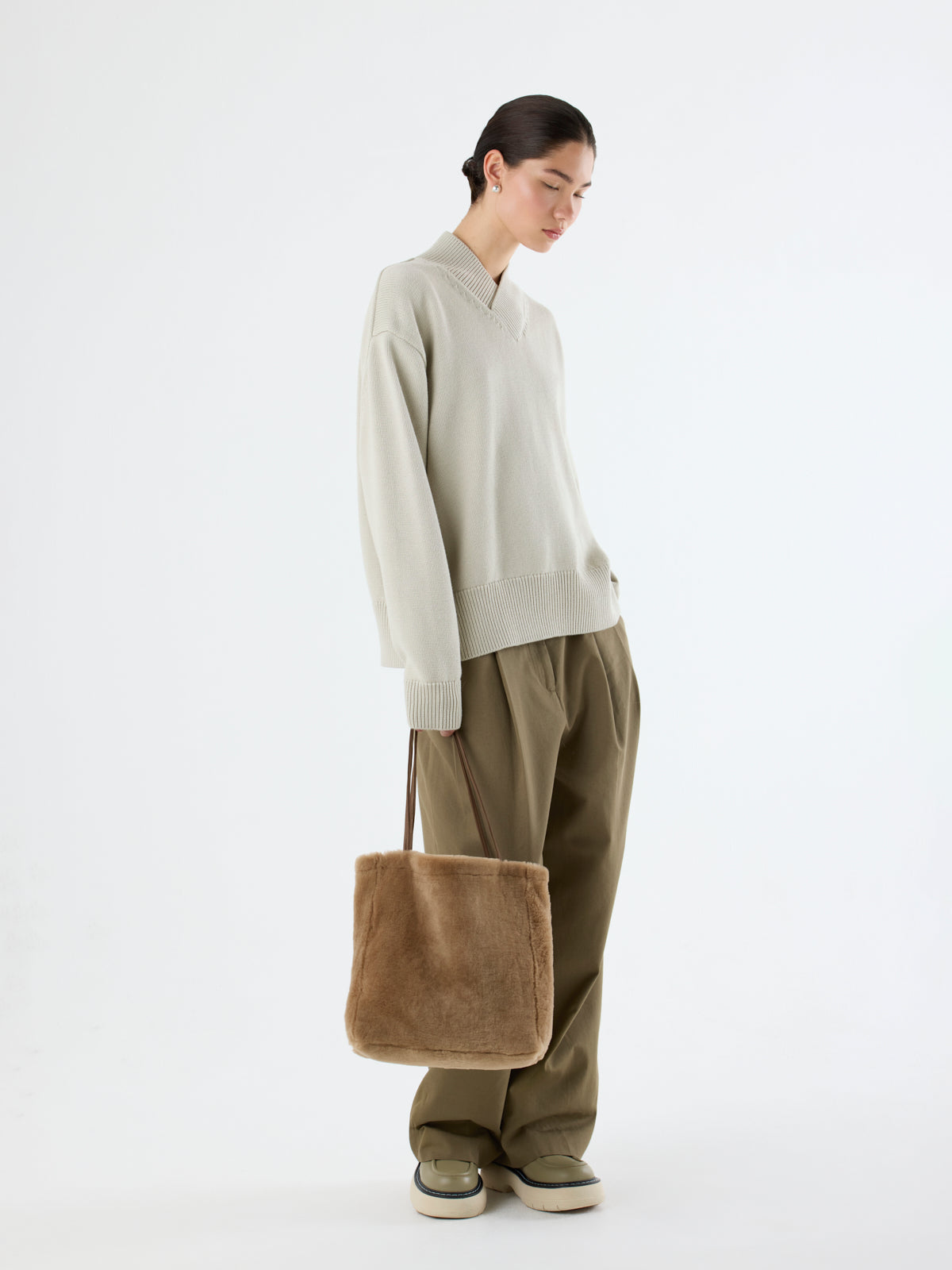 woman holding Tory Camel Shearling Tote Bag by gushlow & cole