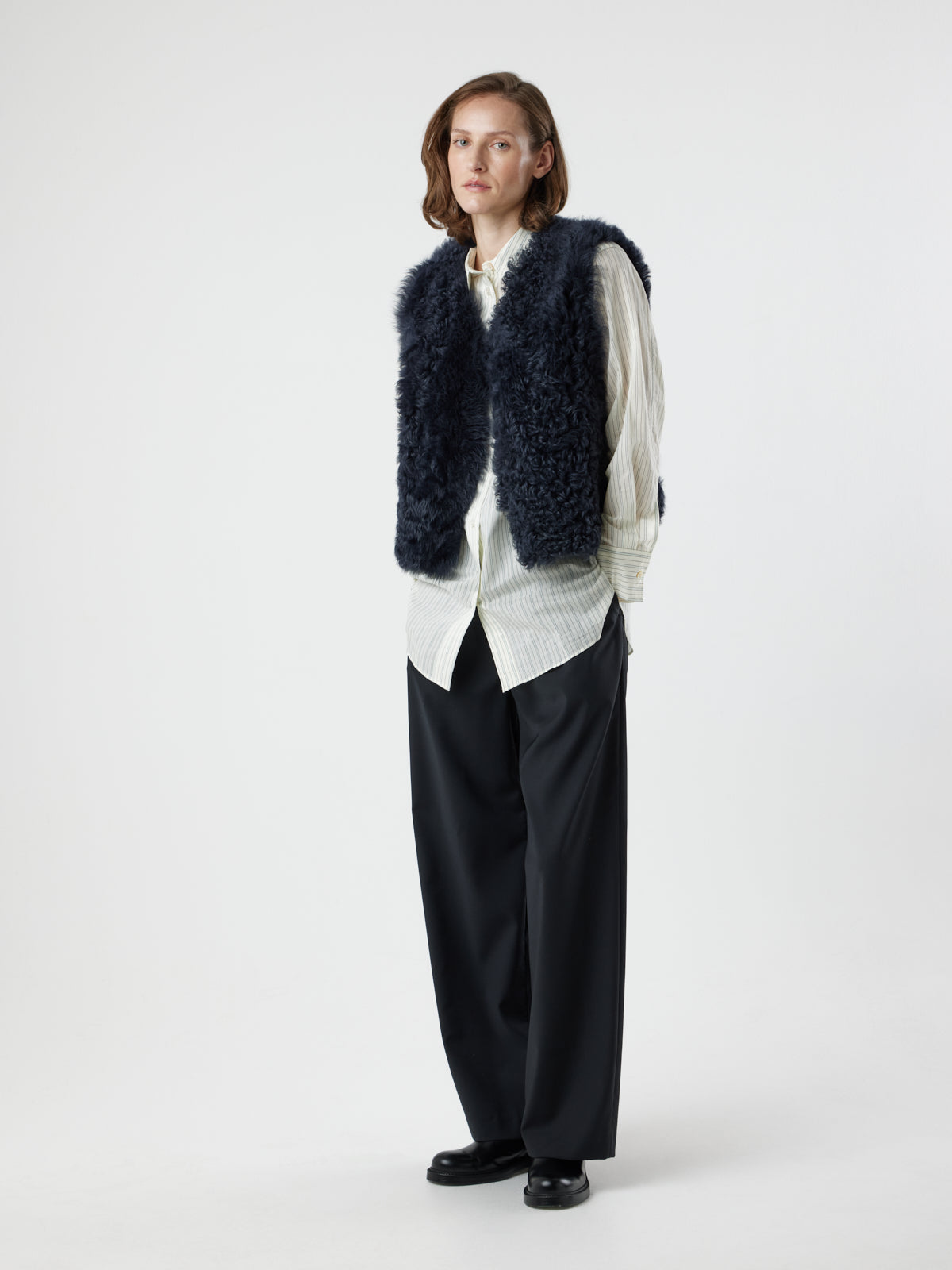 woman wearing two button navy shearling vest by gushlow & cole