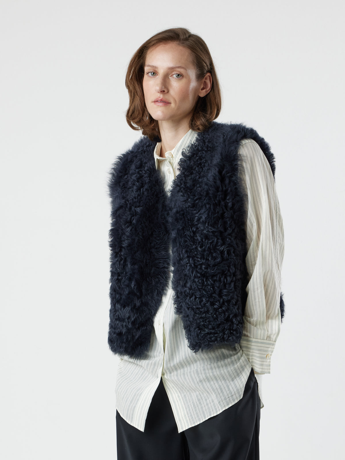 woman wearing two button navy shearling vest by gushlow & cole