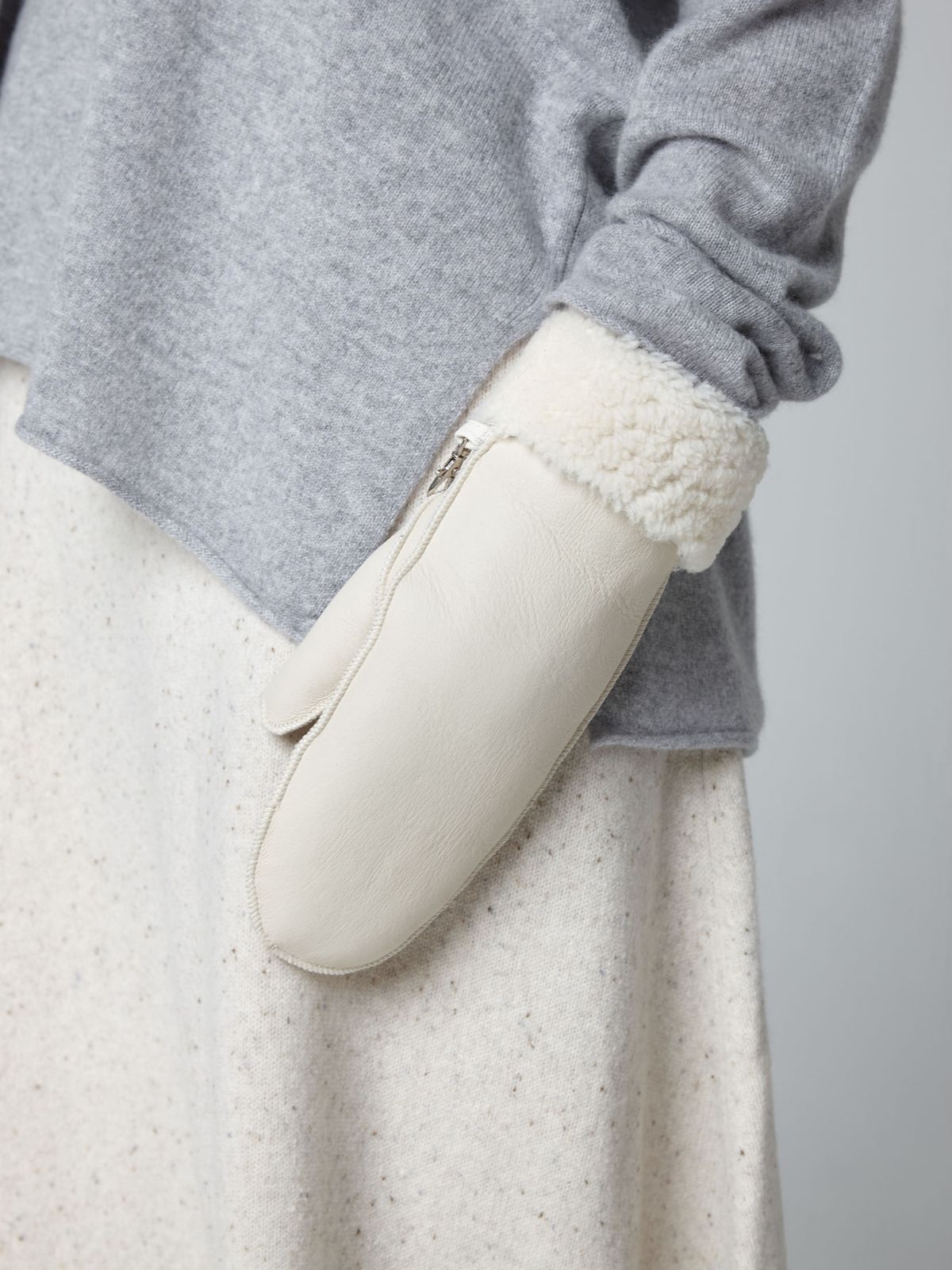 womans hand on white background wearing white full palm shearling mittens by Gushlow & Cole