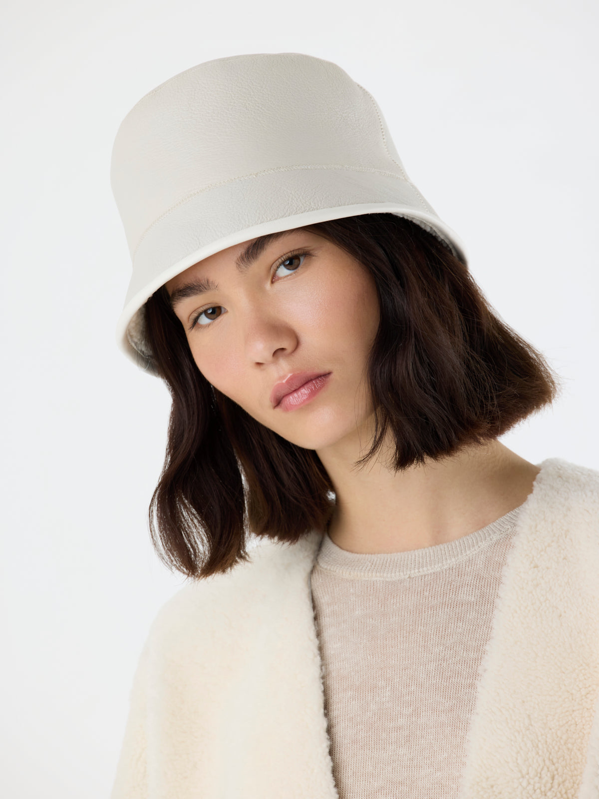 woman wearing white Shearling Bucket Hat with Leather Trim by gushlow & cole
