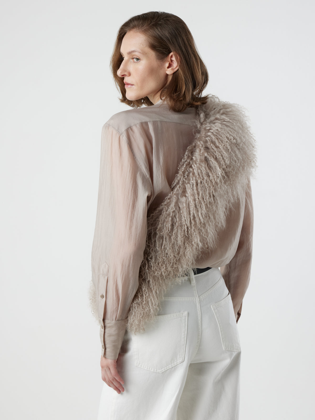 woman wearing oyster White Mongolian Shearling Shawl Scarf styled as sash by gushlow & cole. sheepskin Shawl Scarf