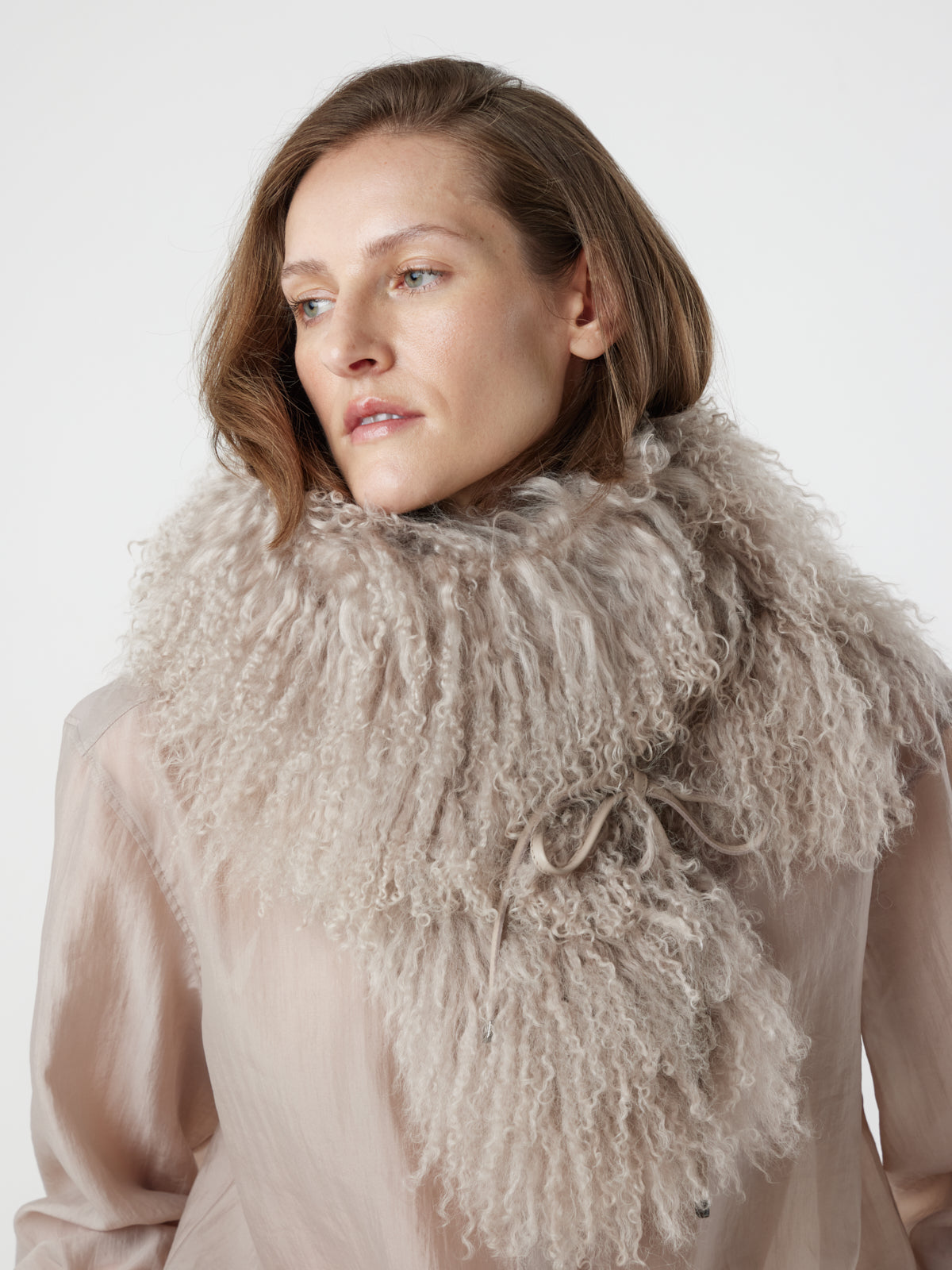 woman wearing oyster White Mongolian Shearling Shawl Scarf styled as snood by gushlow & cole. sheepskin Shawl Scarf