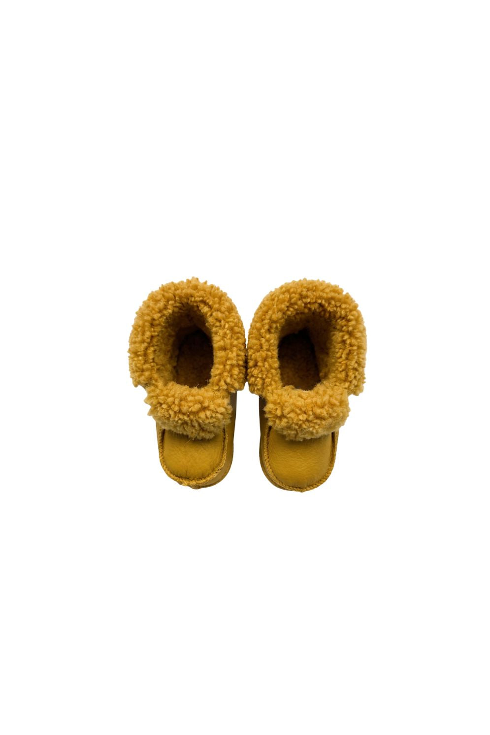 pair of kids yellow sheepskin baby boots on white background by gushlow & cole