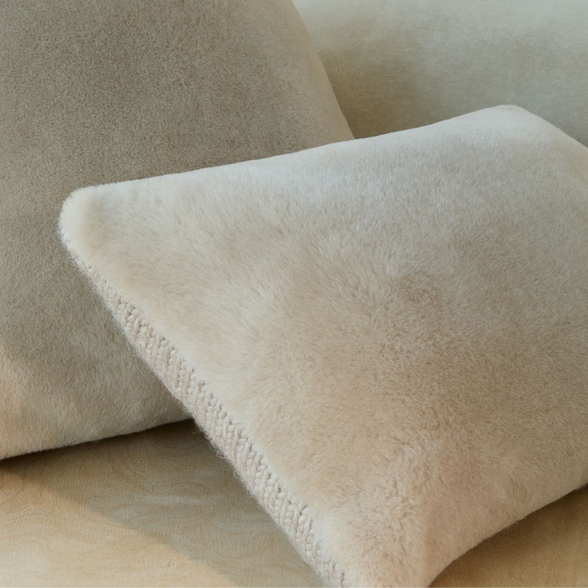 cream shearling and knit cushions by gushlow & cole