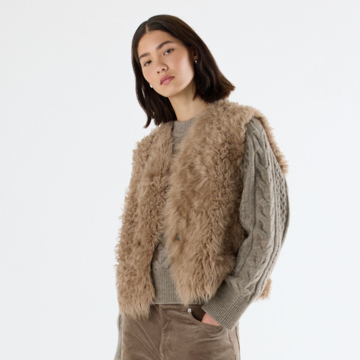 woman wearing camel curly toscana shearling gilet by gushlow & cole